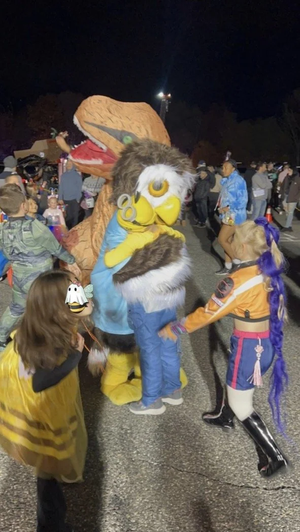 Kids lining up to hug Owlbert.jpeg