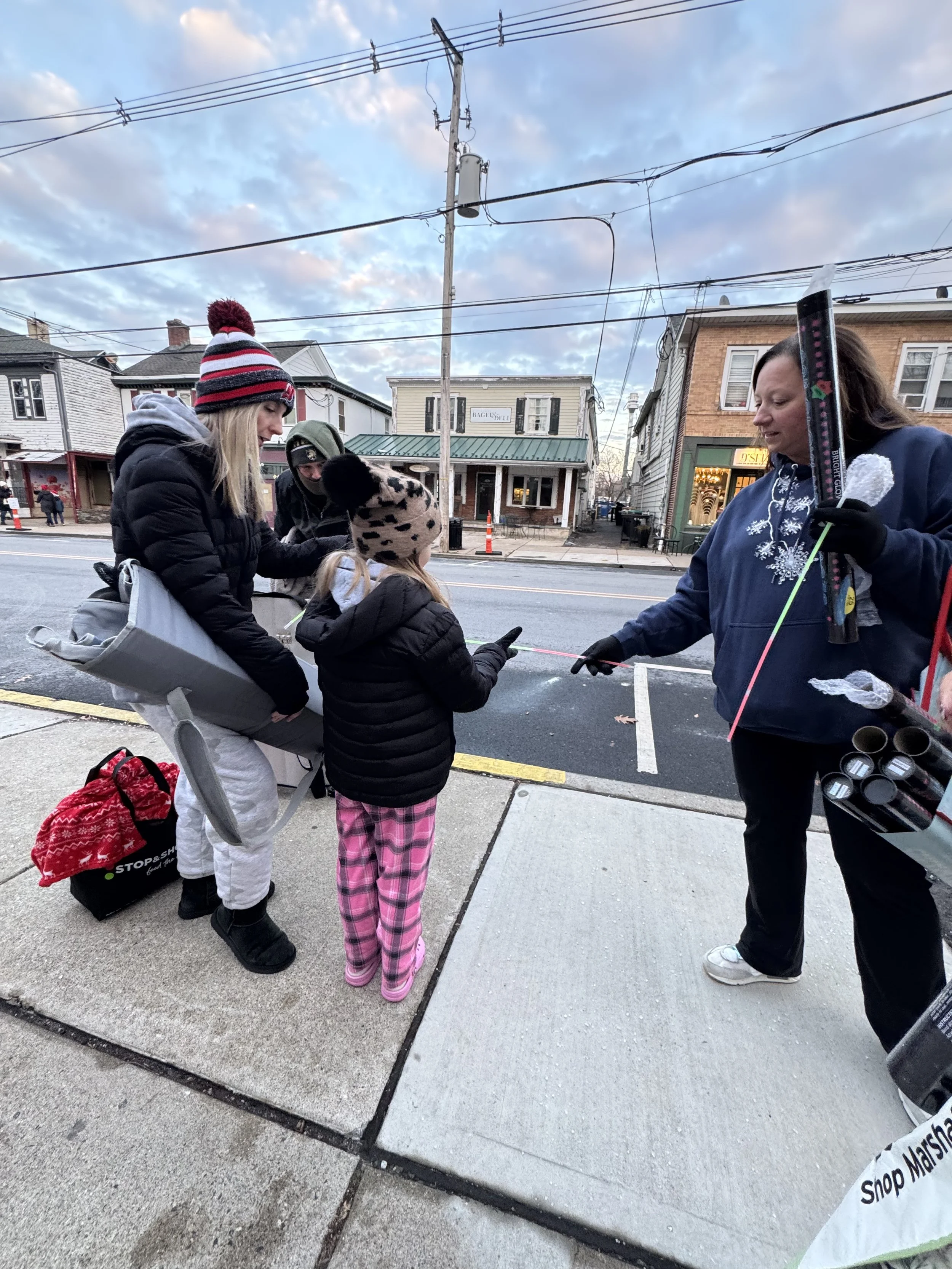 carolanne handing out glow stick.jpeg