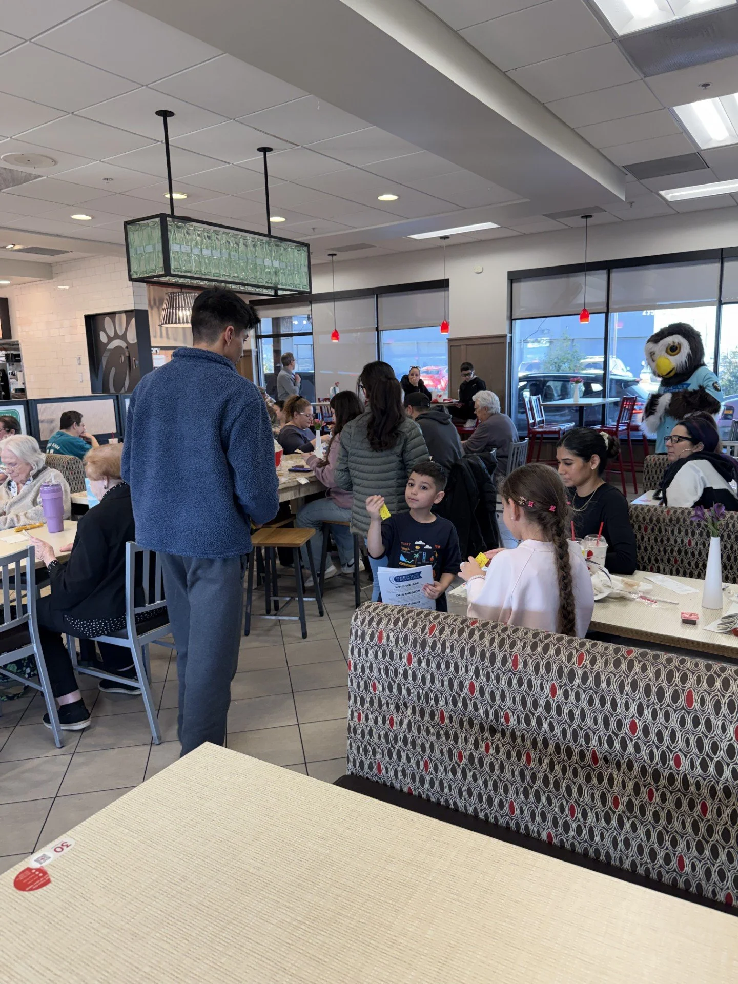 Interns handing out activity books to kids.jpg