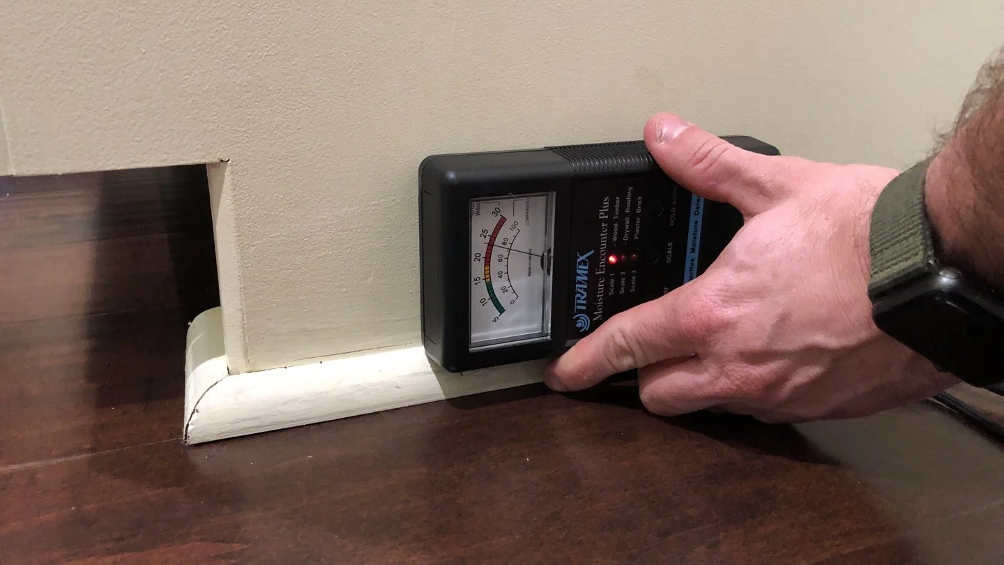 moisture meter finding moisture below cabinet