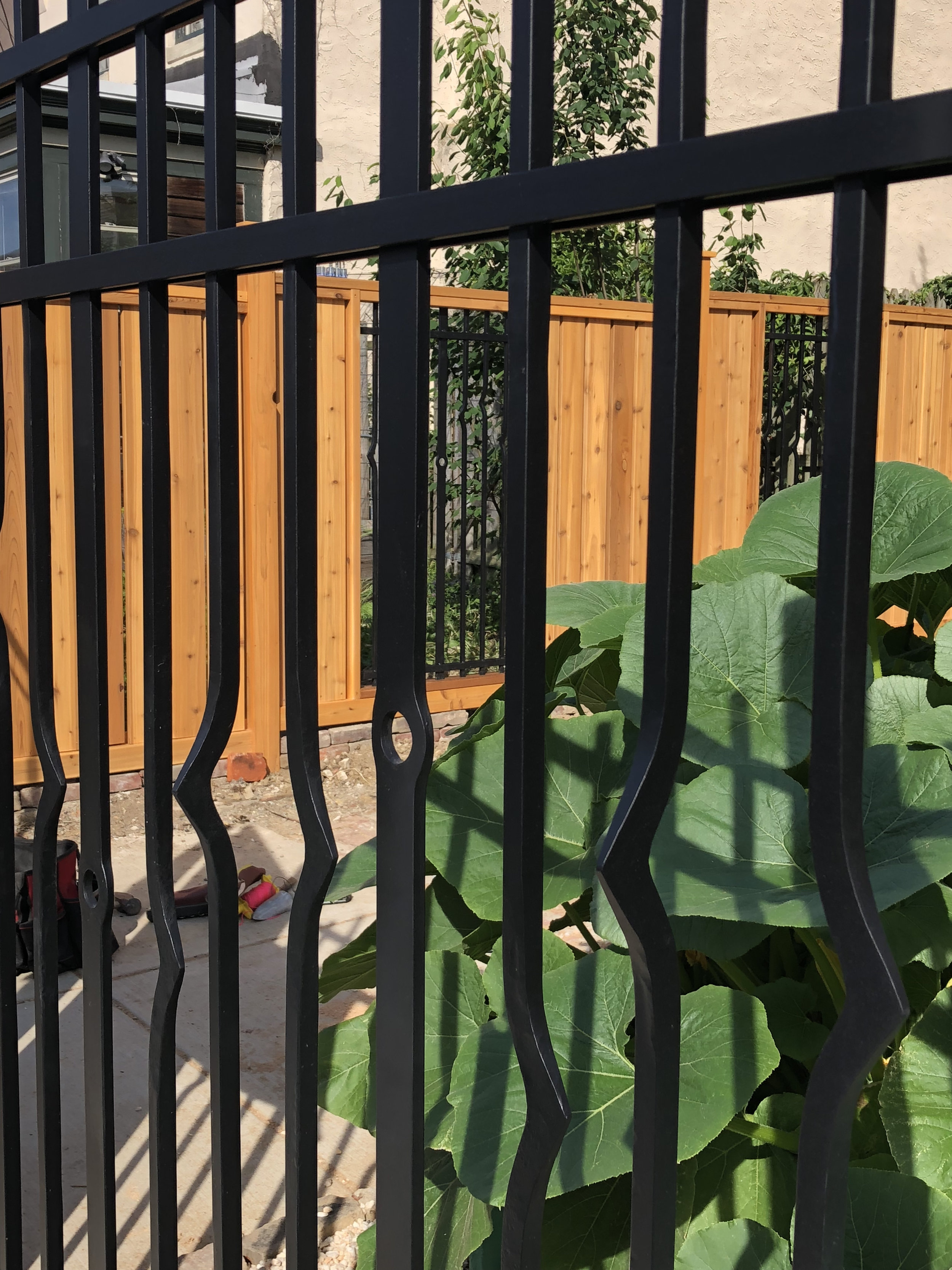 FORGED IRON FENCE WITH CEDAR DRIVEWAY GATE (detail)