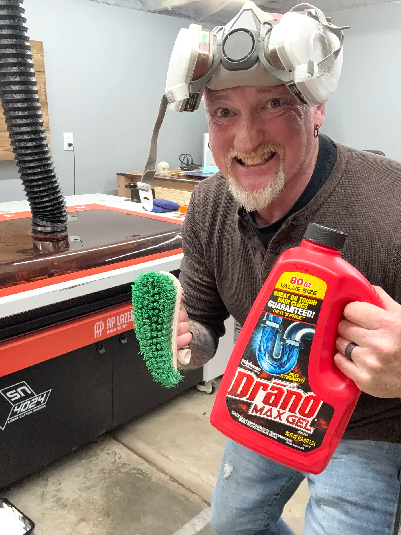 Weird crazy looking dude holding Drano and a scrub brush
