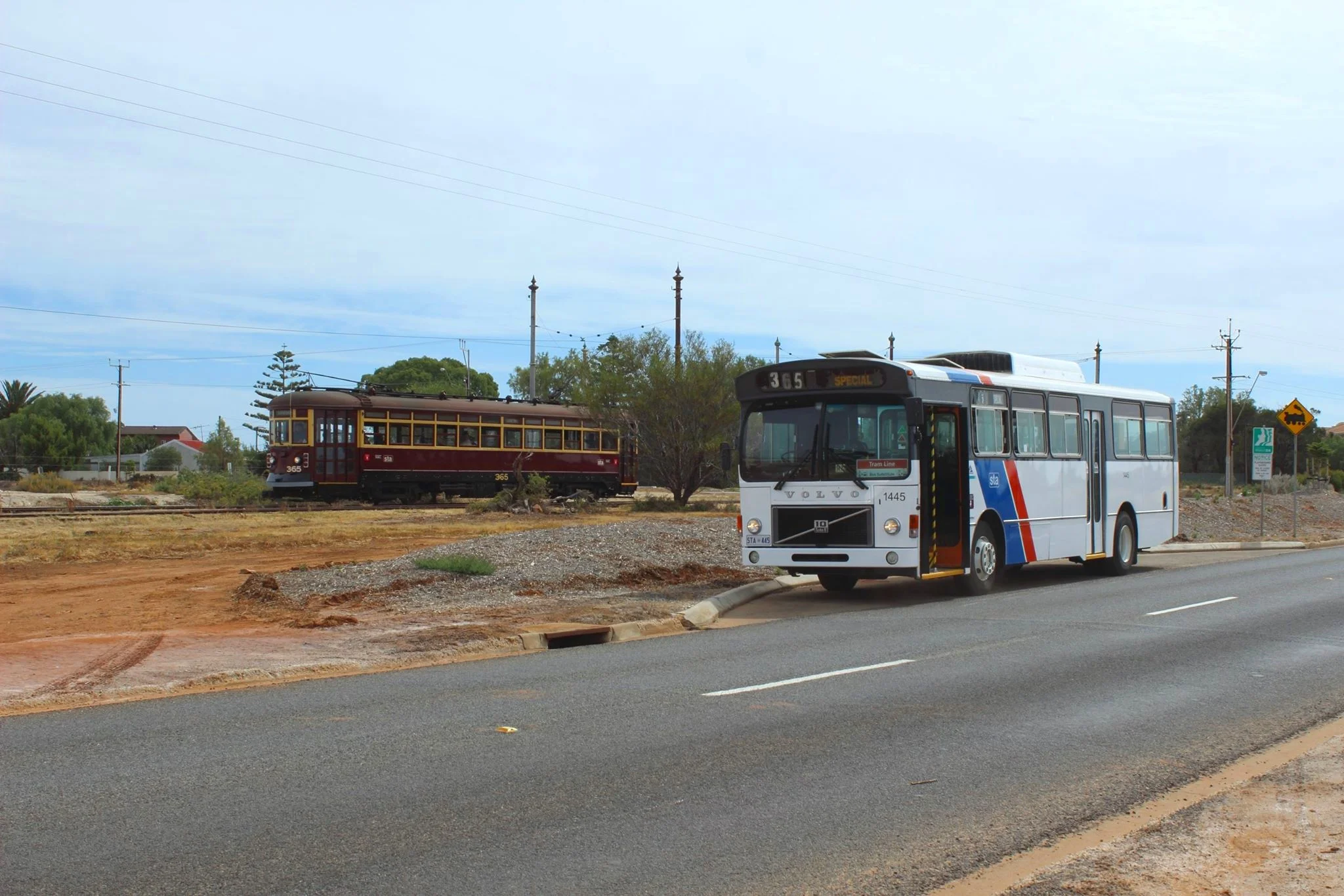 VOLvo b58 “Brown Bomber” No. 1445 in STA Speed STRIPE LIVERY poses for a photo with H-Type 365