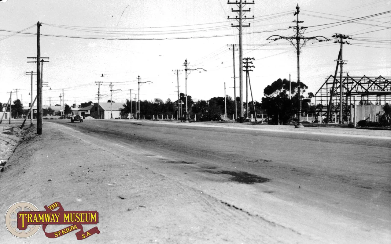 The line to Albert Park ran on the eastern side of the generous expanse of the Port Road median strip and was single track after leaving the Commercial Road precinct. In this photo, the overhead poles show the point where the double track section ended in Port Road. The Port Adelaide depot is out of frame to the left.