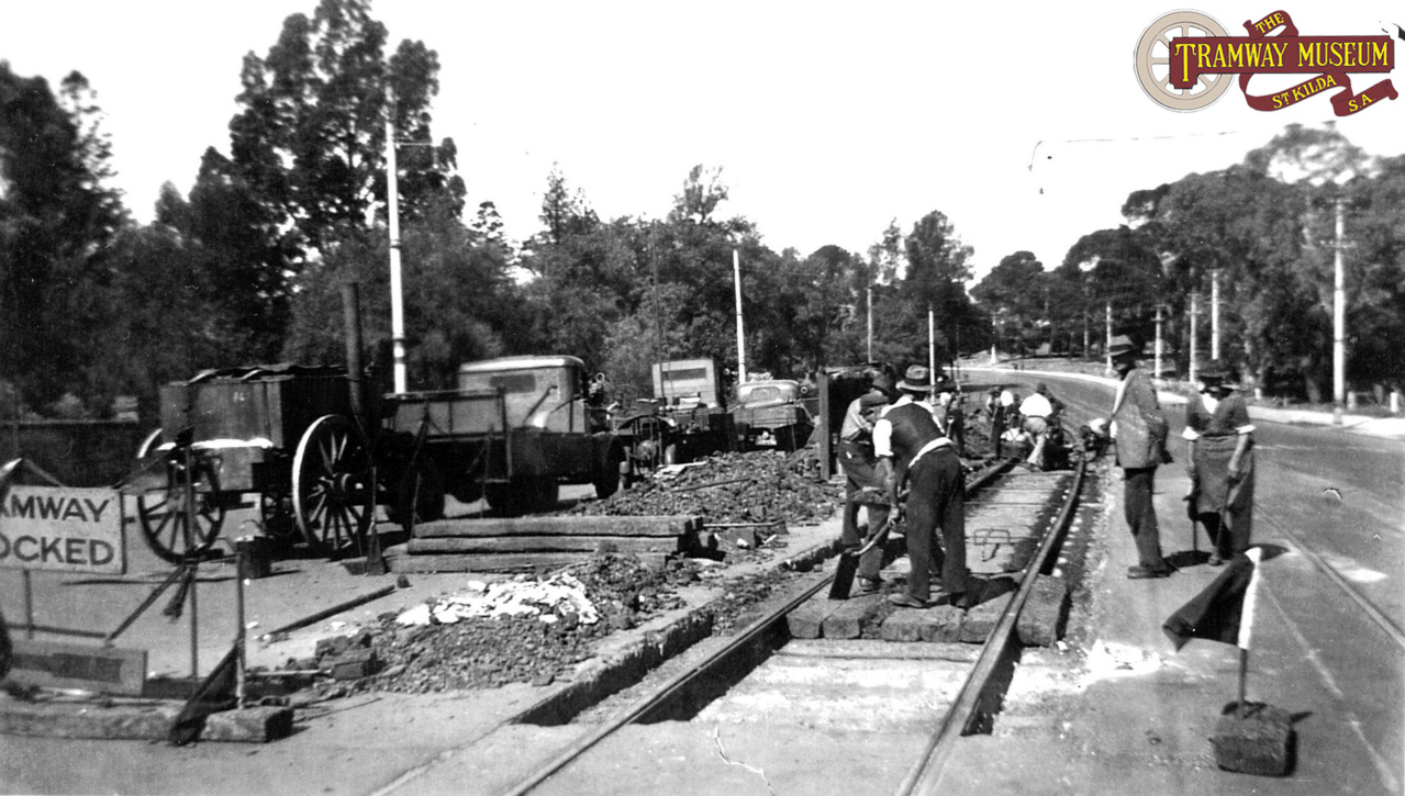   When the rails in the tramway finally became too worn to use, the track gang would dig up the road surface and replace the rails. Seen here in 1942 near the Botanic Gardens on North Terrace, the track gang have already removed the old rails and are