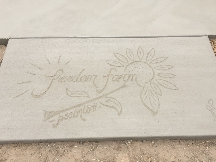 Freedom Farm Inscription in concrete with Psalm 68:11.jpg