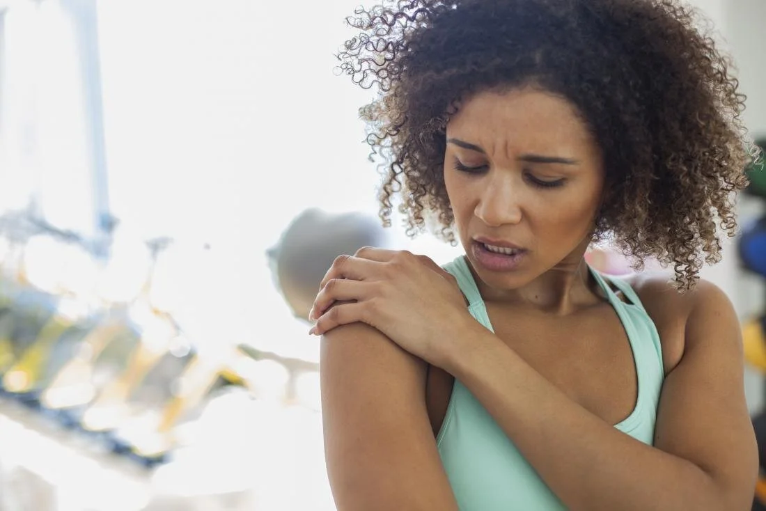woman-with-shoulder-subluxation-holding-shoulder-joint-in-pain.jpeg