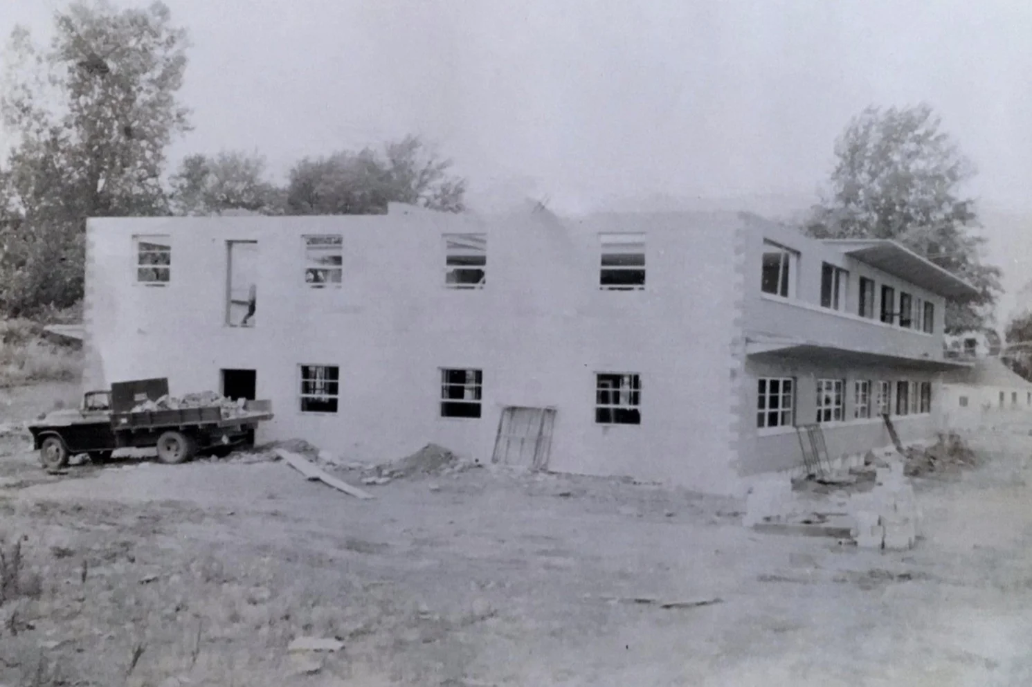 View of the east and north sections of Johnson, Depp and Quisenberry in June of 1958. Not that the majority of the Double-T concrete roofing system have been installed. The door in the upper left-hand corner was the fire-escape.