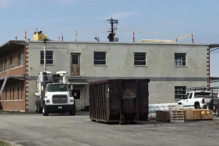The back of The JDQ Building in 2016 while the old roof was being removed and the new roof installed.