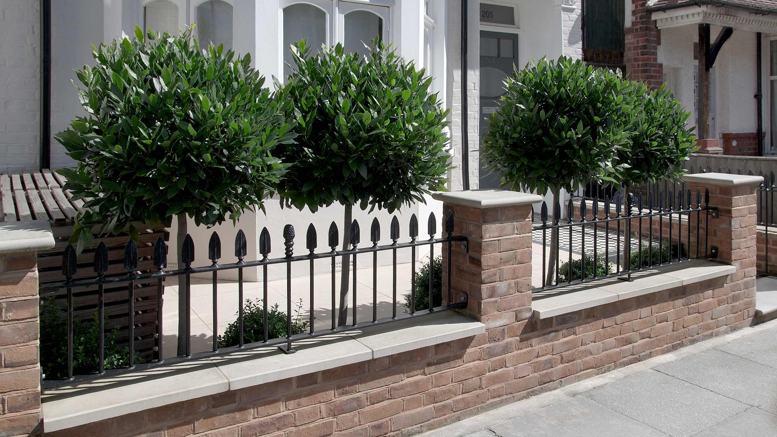 Elegant front exterior, clipped bay trees. Garden design &amp; build near Farnham, Surrey