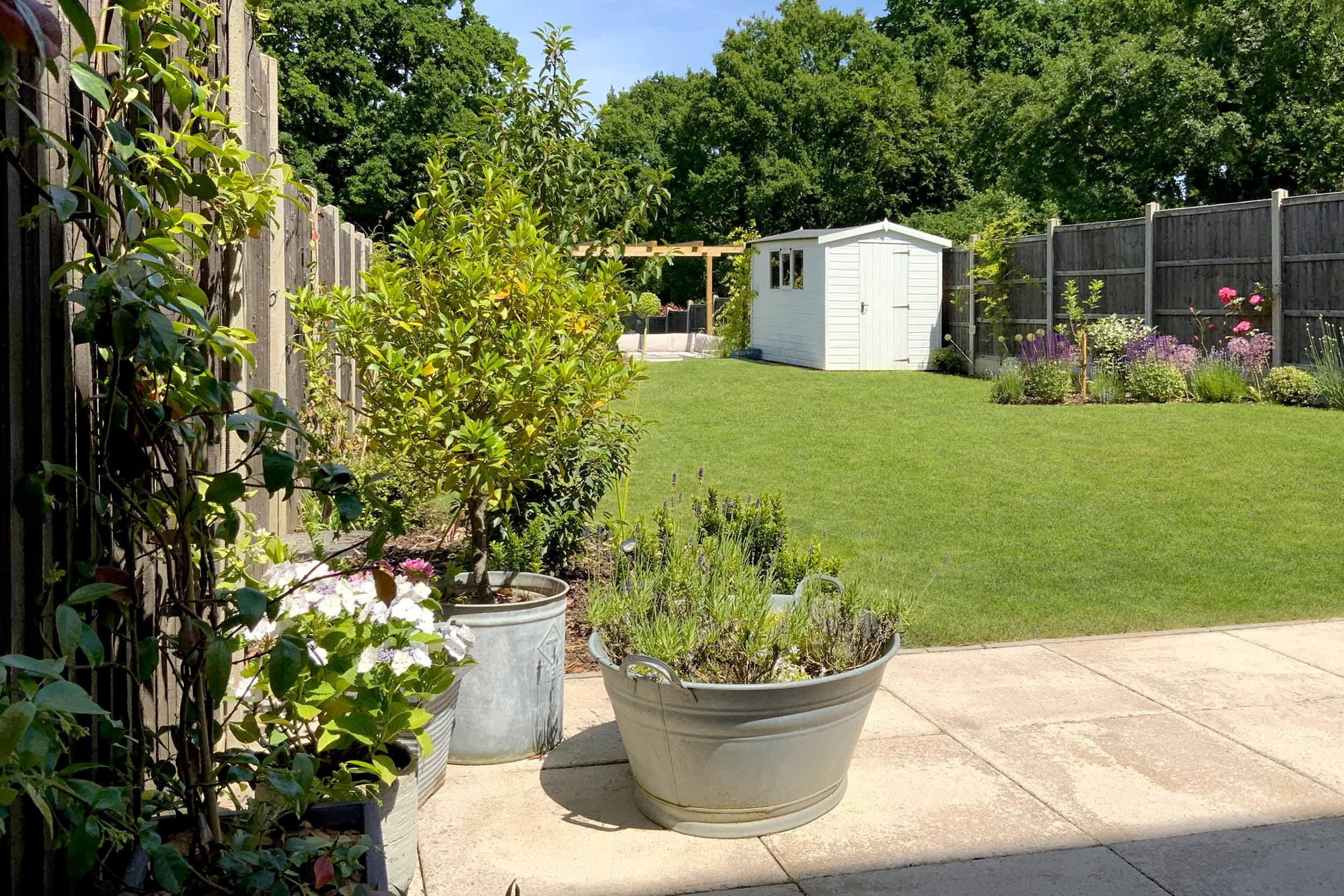 New build garden with timber pergola and curved lawn. Garden design &amp; build near Farnham, Surrey