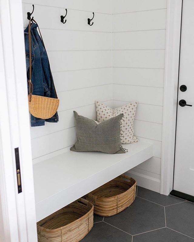 This laundry room had so many details that we loved! The large dark tiles are perfect for a highly trafficked area like a mudroom space. This custom floating shelf is both beautiful and functional. The shiplap walls add classic interest. And the pock