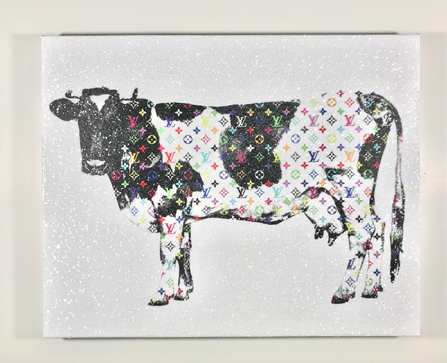 holstein cow covered in expensive logos