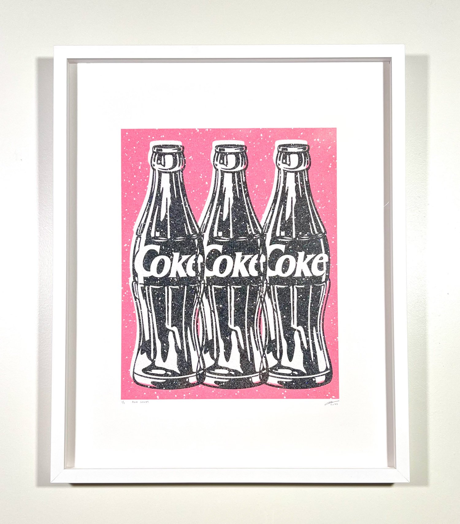 3 Coke bottles with pink background
