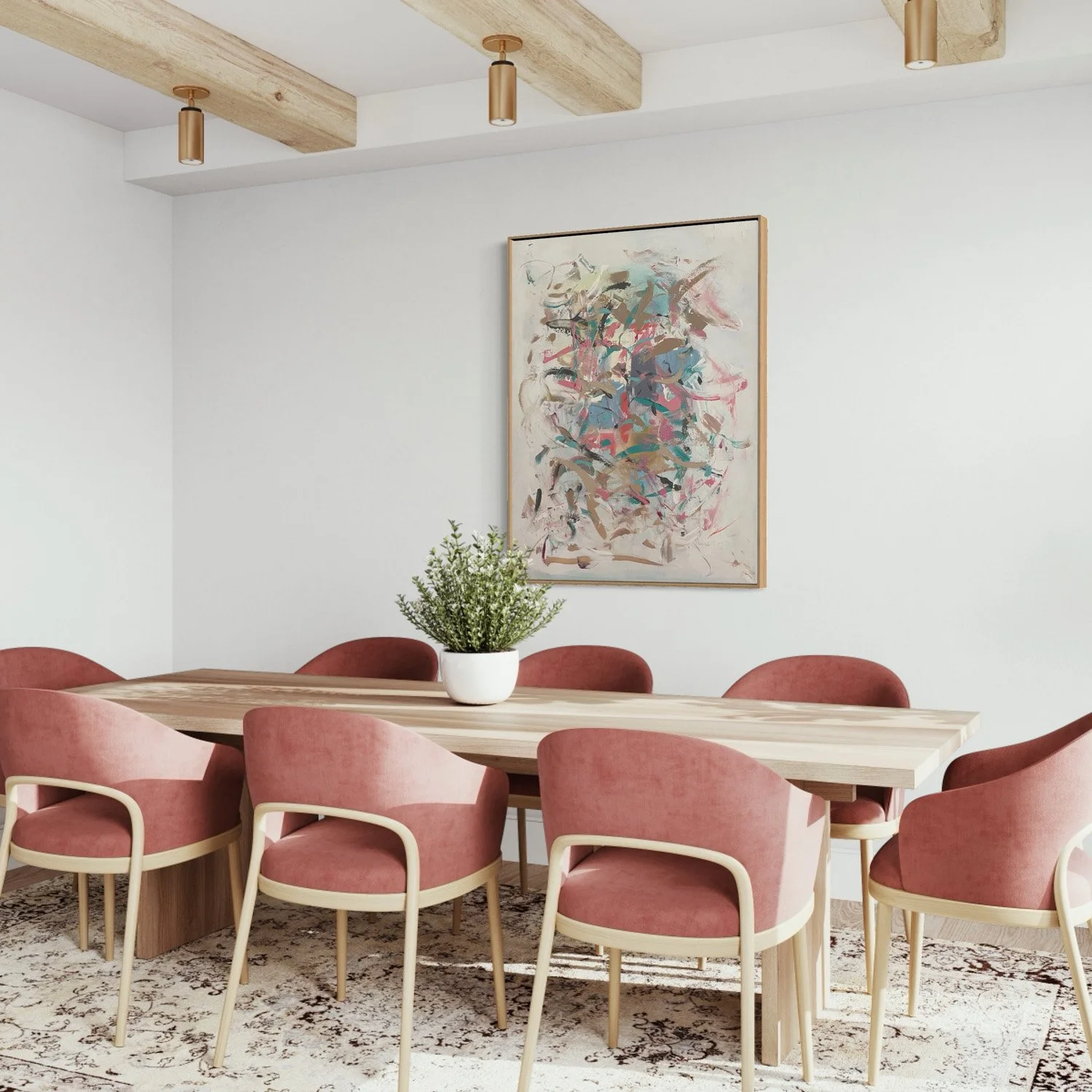 abstract painting hanging above dining table with pink chairs