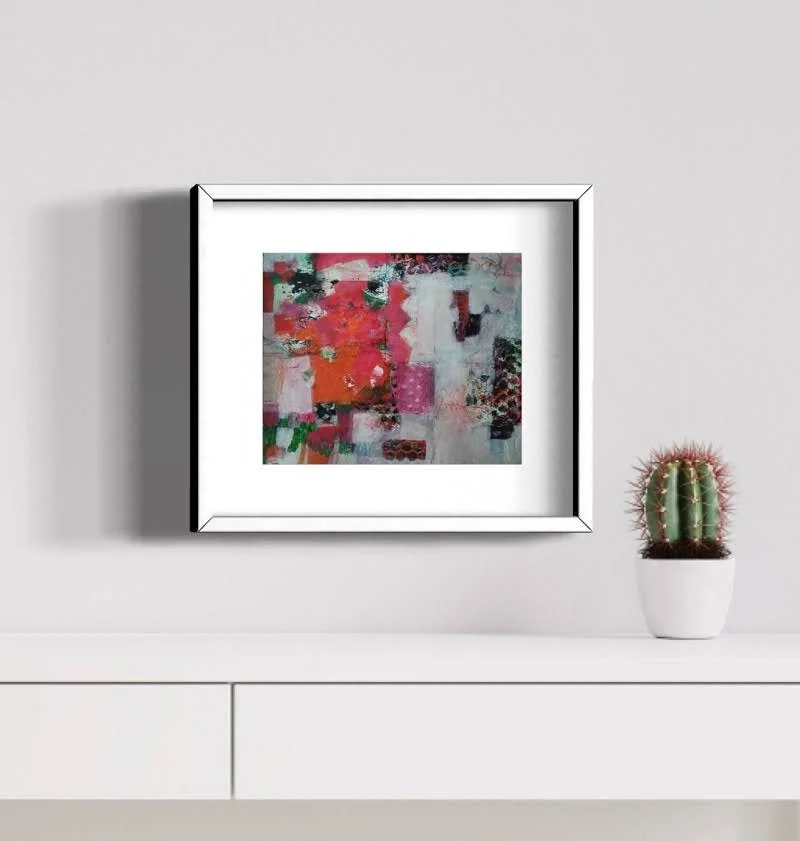 Building Blocks framed in white, amongst white furniture