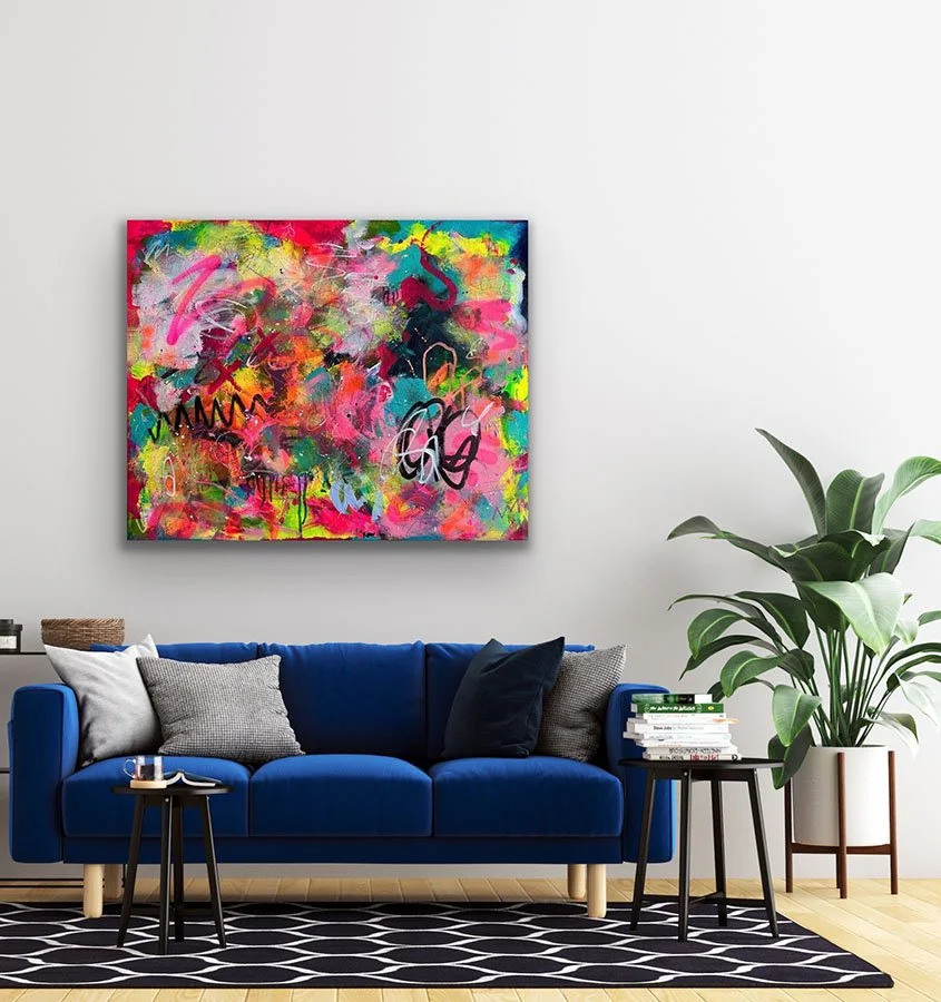 Gratitude painting hanging on wall above sofa