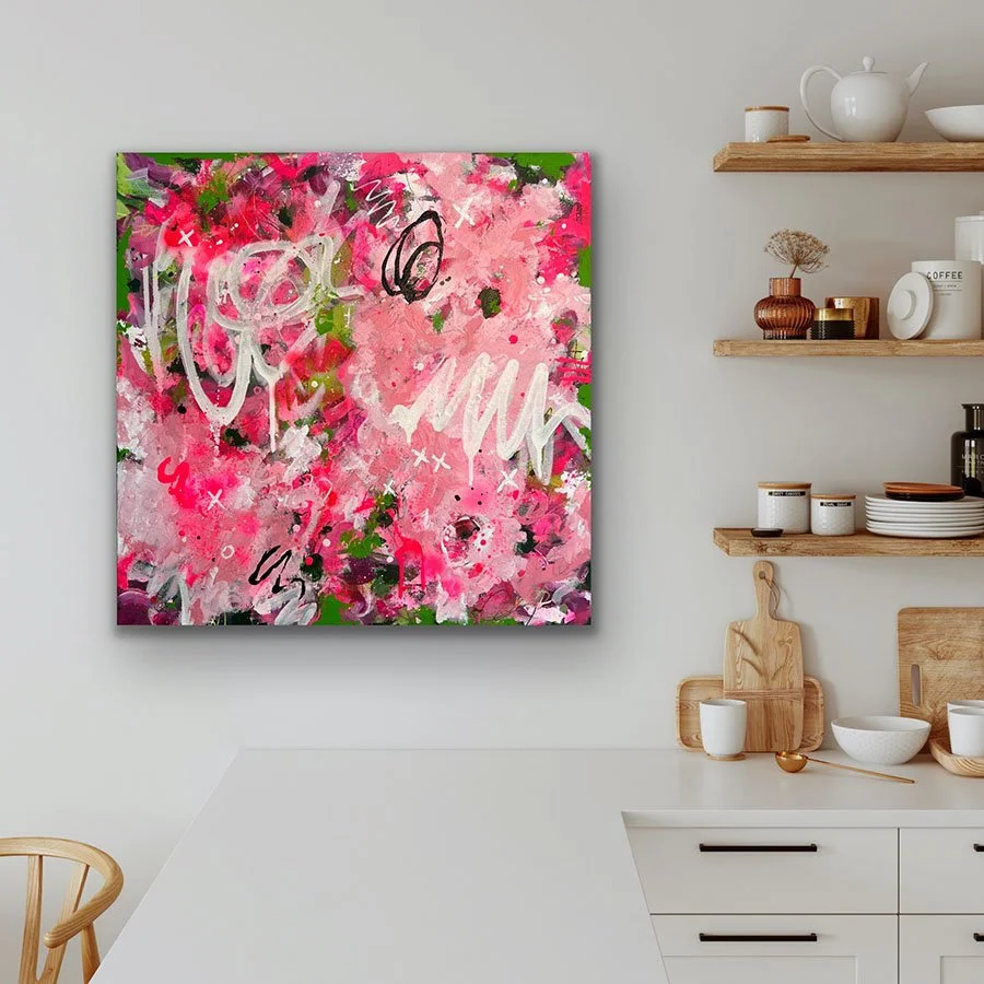 Abstract Summer painting hanging on wall by kitchen shelves with dishes