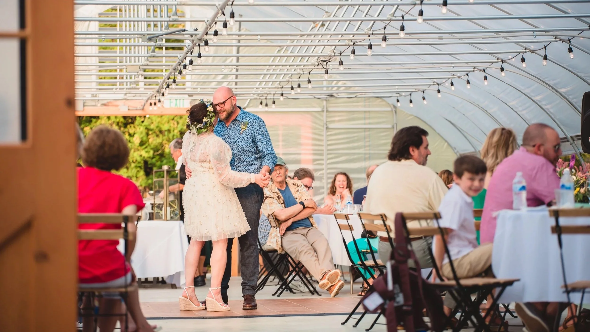 Drew and Lauren dancing together at their wedding reception, a candid film still