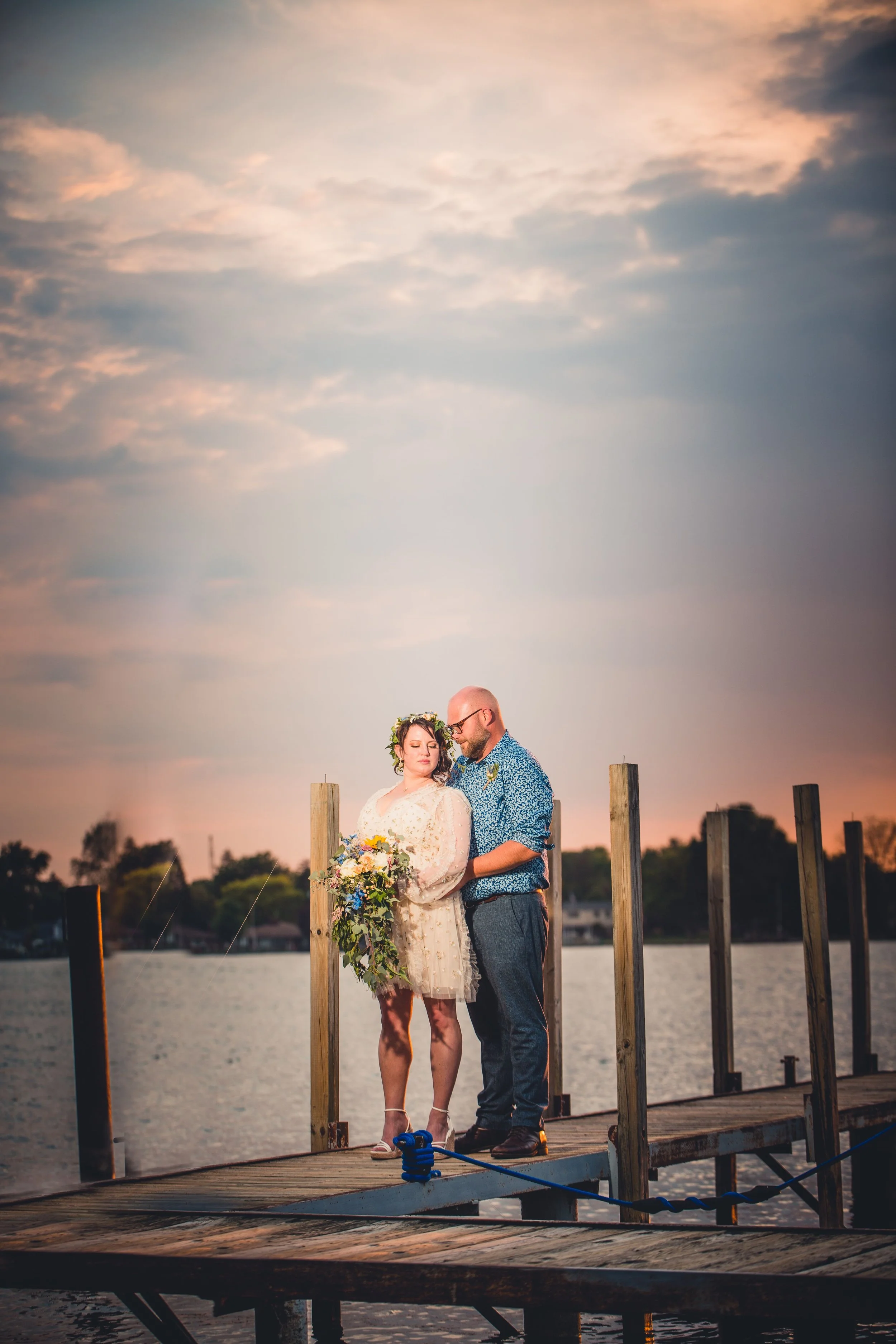 Drew and Lauren together on a dock at sunset, a candid film still