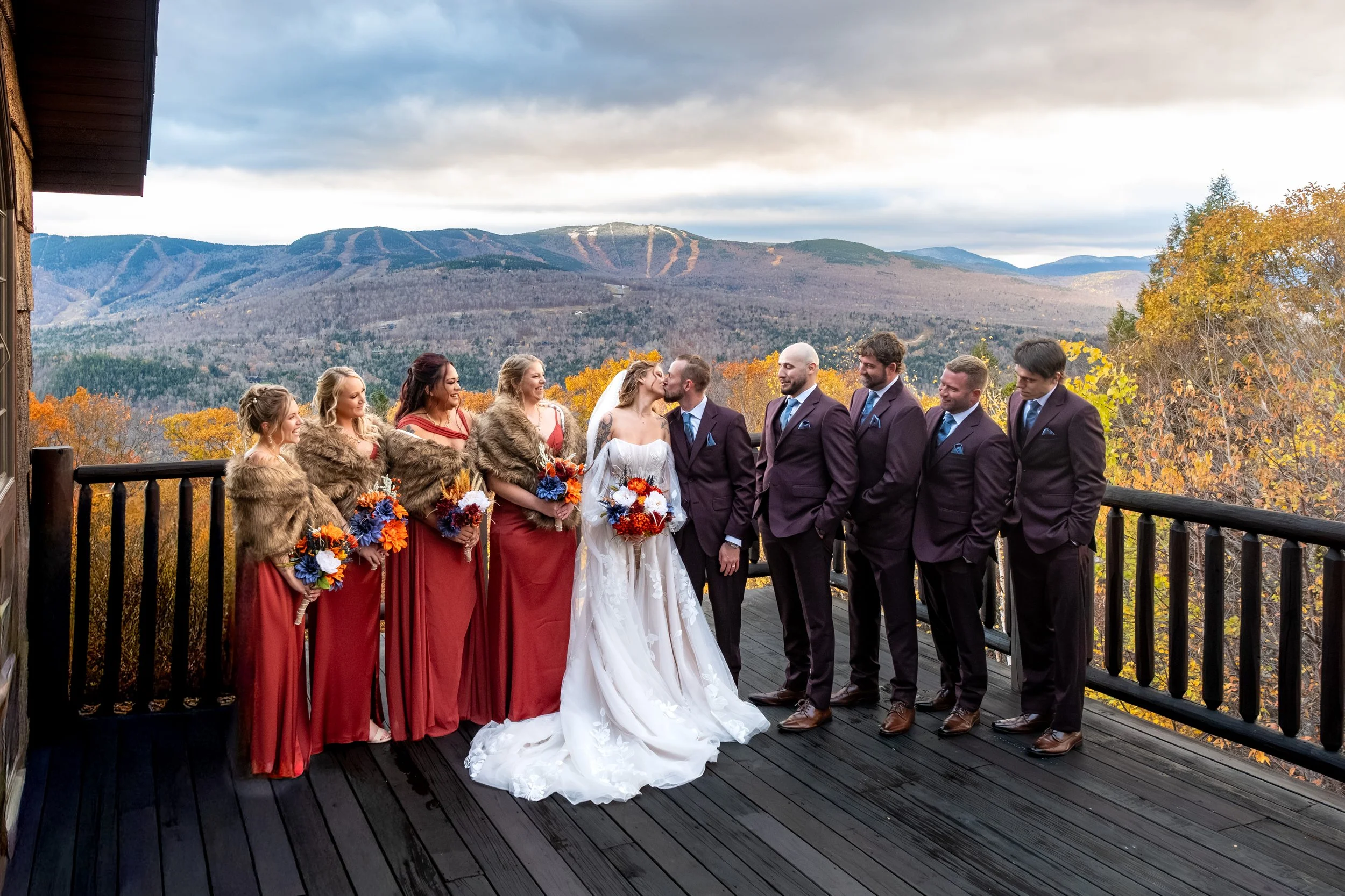 Sarah Steve full wedding party kiss on SkiEsta deck mountain view Newry Maine fall wedding VMG Productions