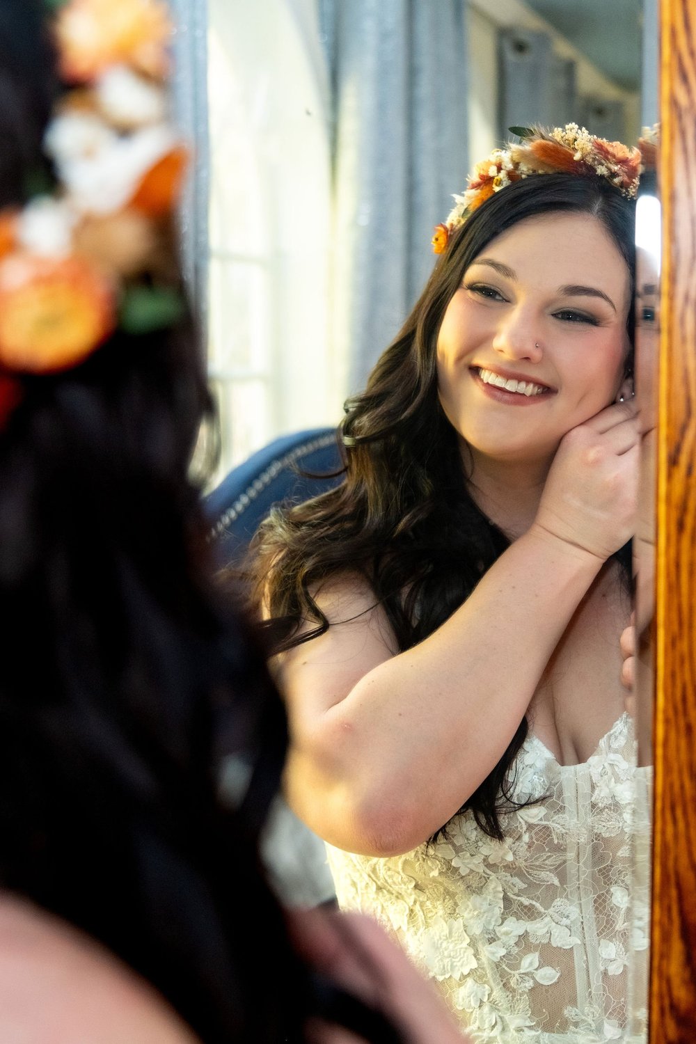 Meagan adjusting earring in mirror at The Watson Homestead Hiram Maine fall wedding photography VMG Productions