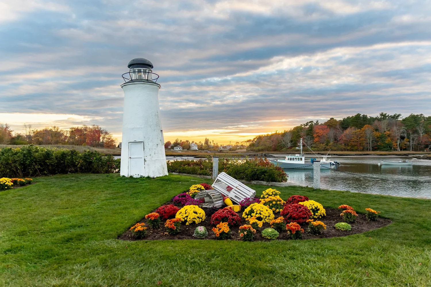 Kennebunkport lighthouse and harbor with fall foliage at sunset coastal Maine wedding VMG Productions