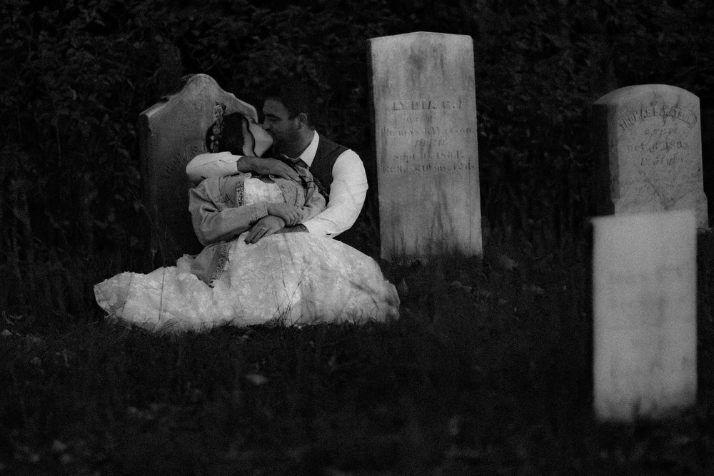 Meagan and Joshua kissing in black and white cemetery portrait at The Watson Homestead Hiram Maine fall wedding photography VMG Productions