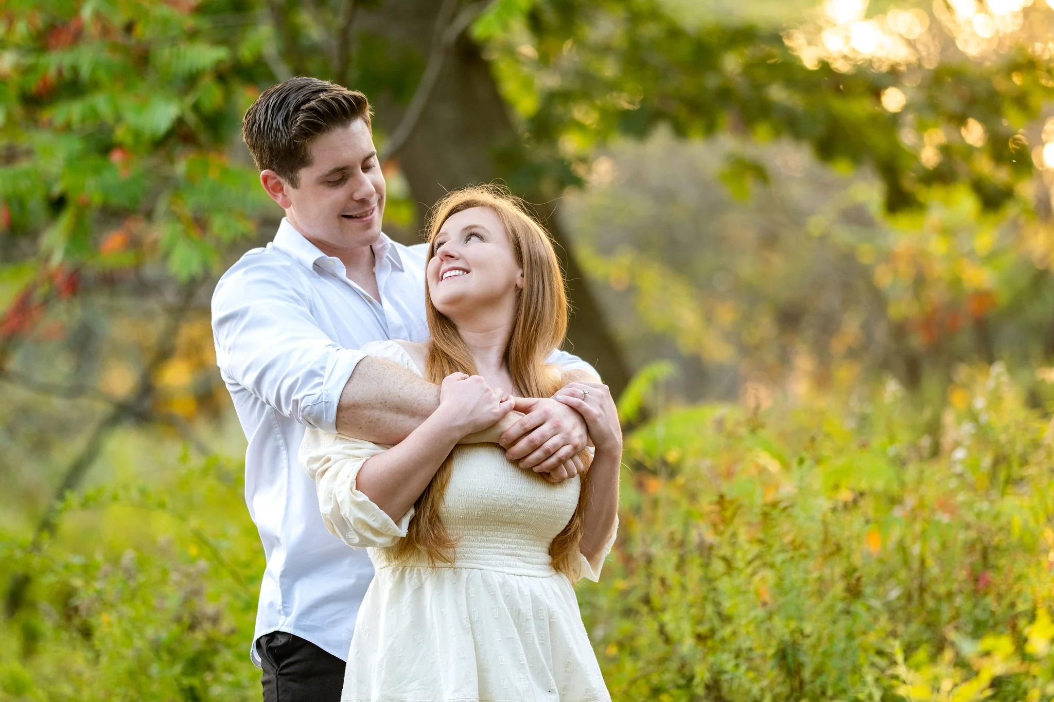Kayla and Ethan engaged couple backlit embrace golden hour Odiorne Point State Park New Hampshire engagement photography VMG Productions