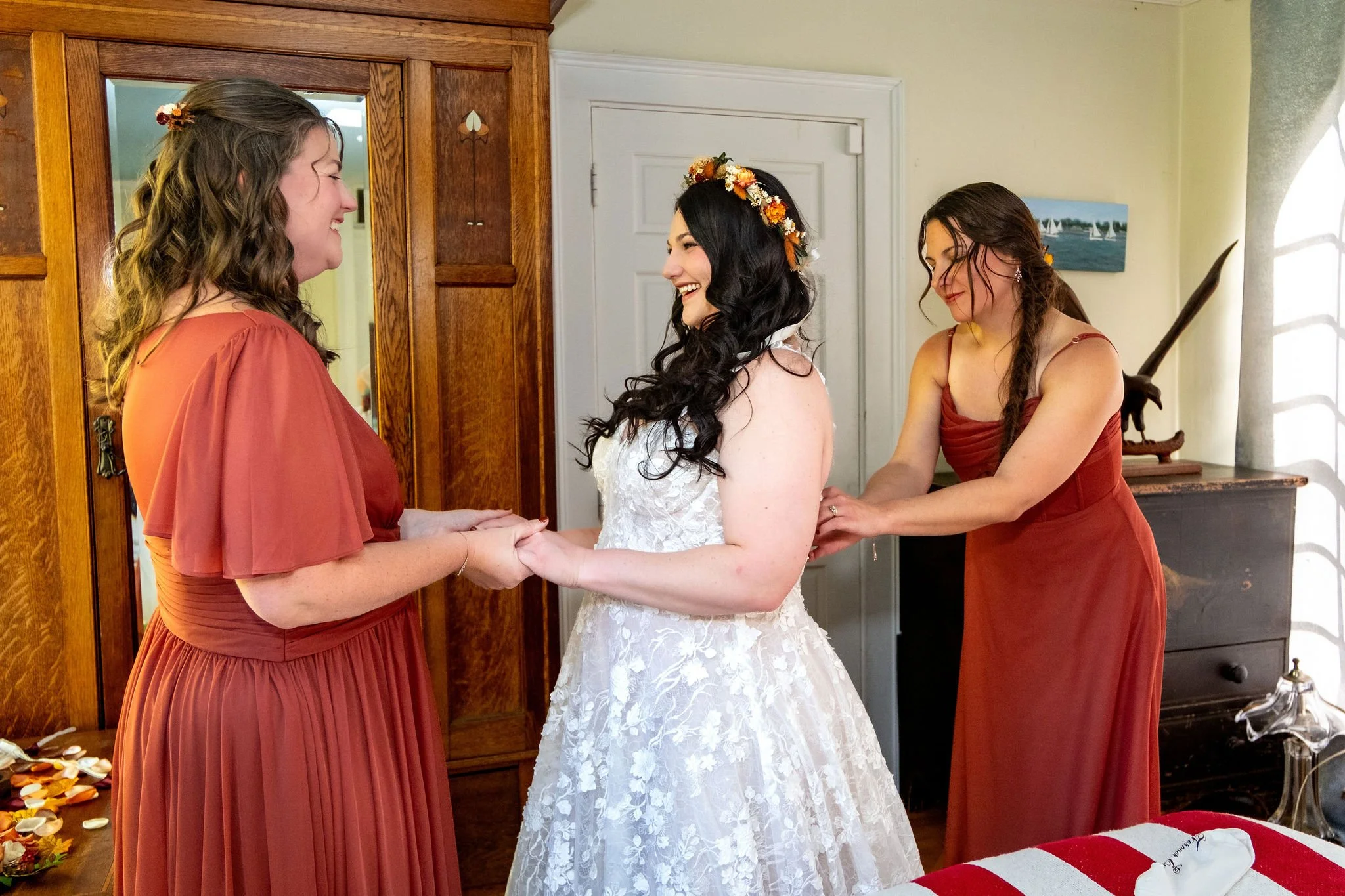 Meagan getting ready with bridesmaids in carriage house at The Watson Homestead Hiram Maine fall wedding photography VMG Productions
