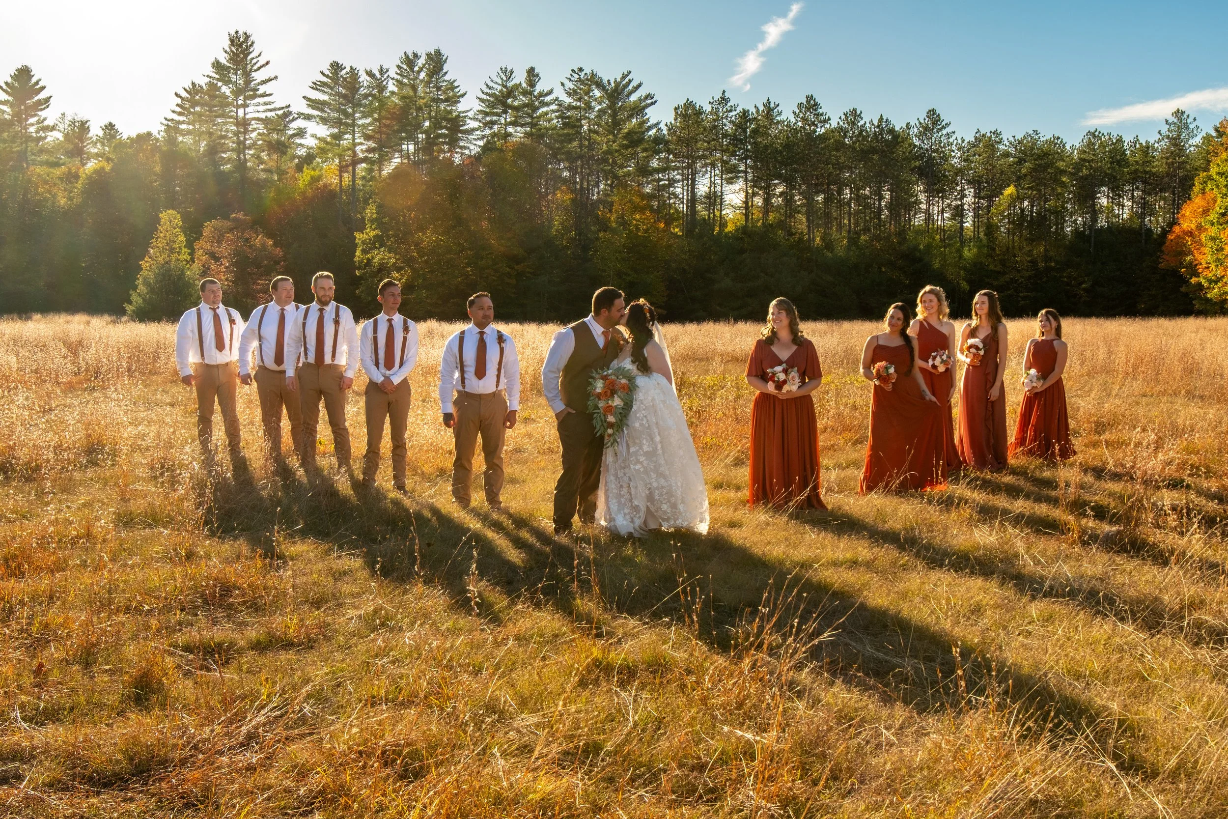 Meagan and Joshua with wedding party in golden field at The Watson Homestead Hiram Maine fall wedding photography VMG Productions
