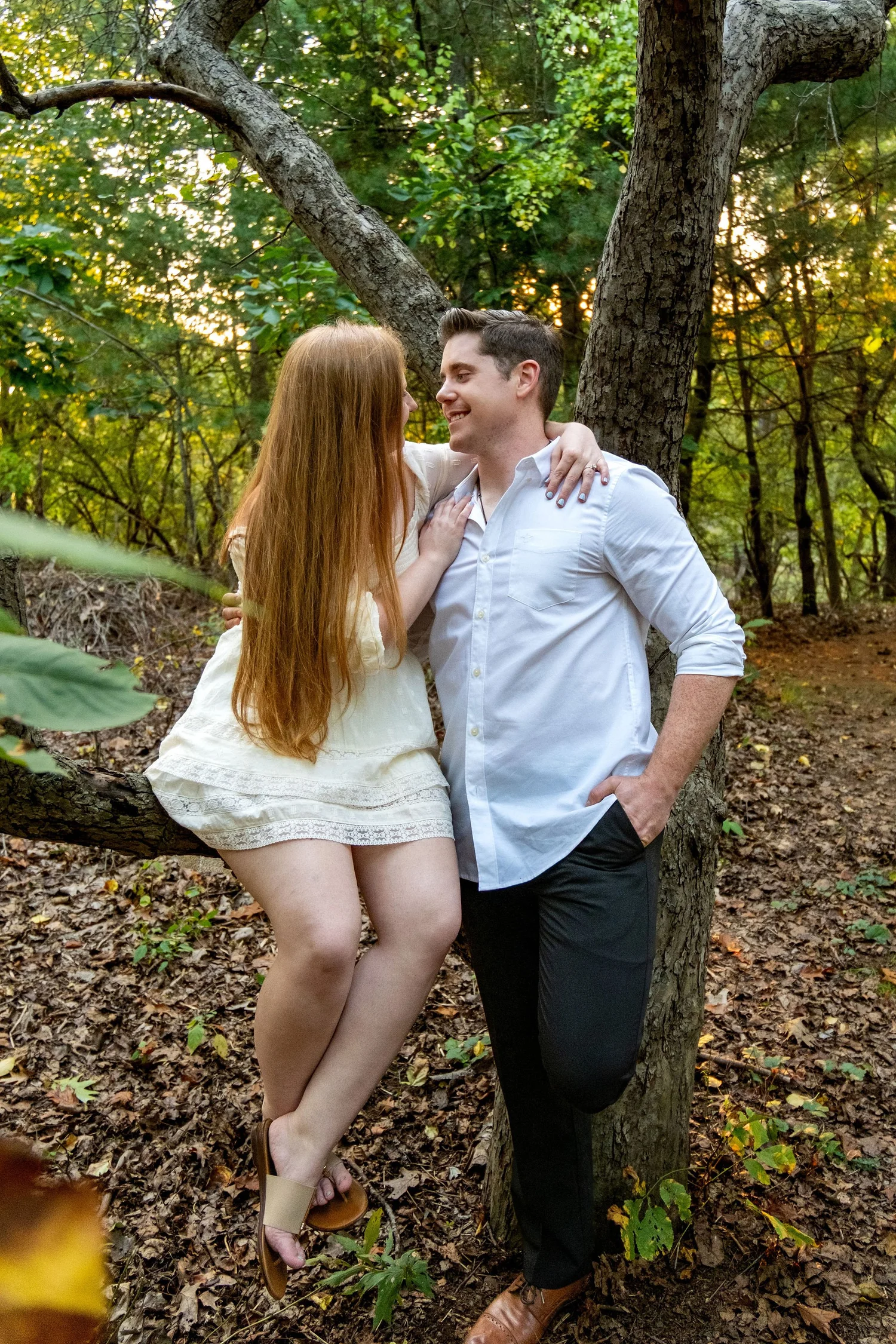 Kayla and Ethan engaged couple laughing in tree woodland Odiorne Point State Park Rye New Hampshire engagement photography VMG Productions