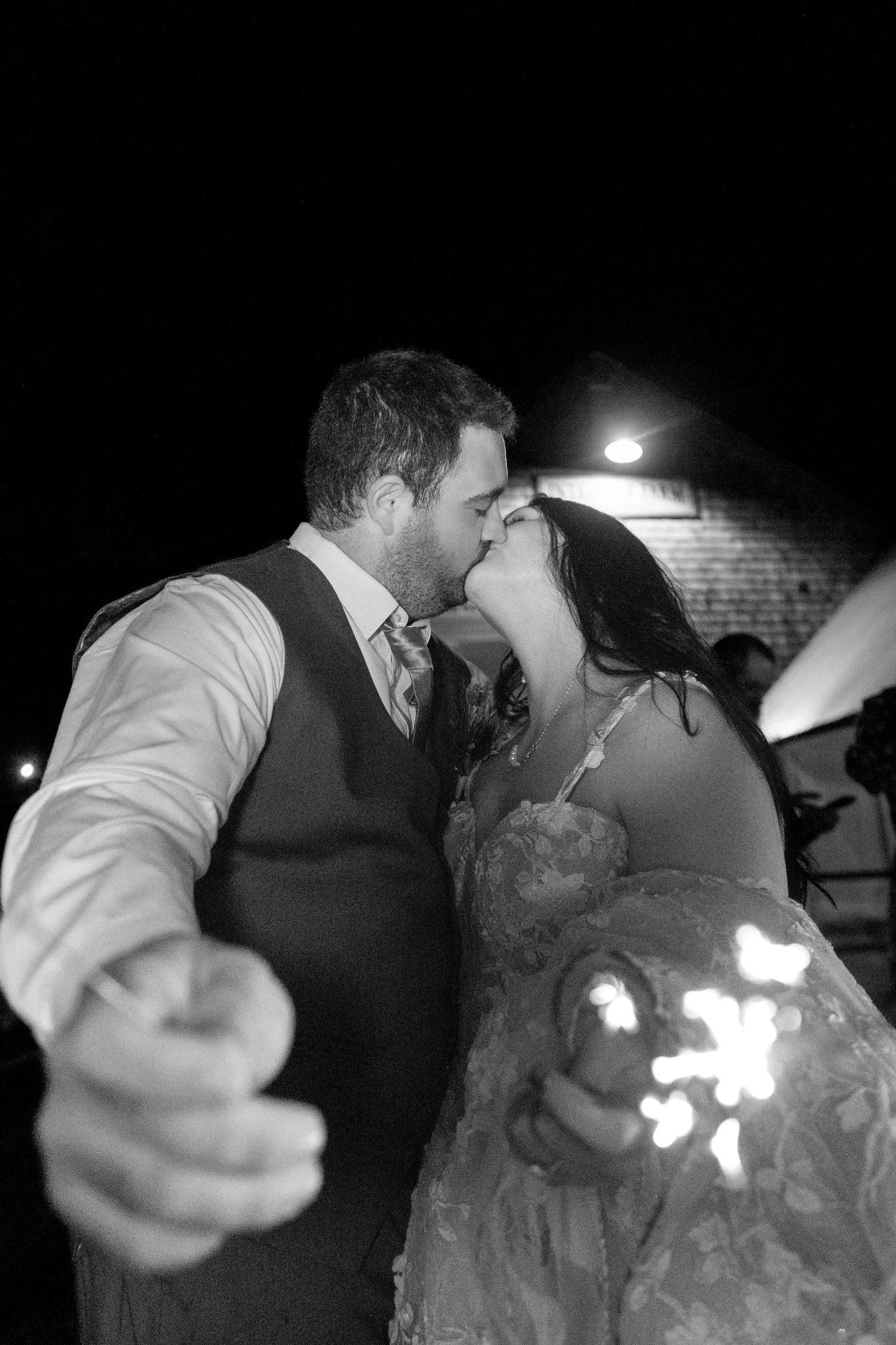 Meagan and Joshua black and white sparkler kiss at The Watson Homestead Hiram Maine fall wedding photography VMG Productions