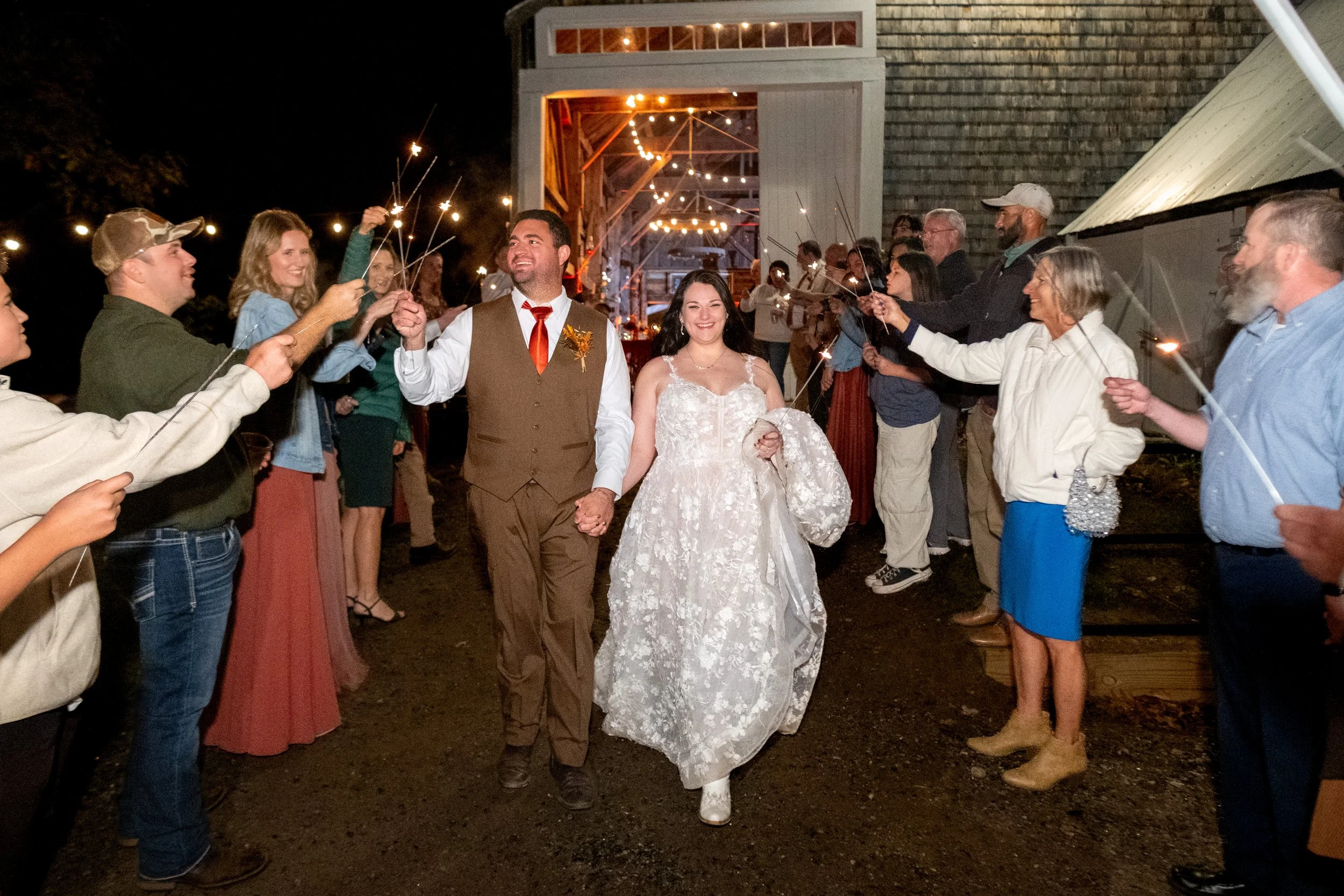 Meagan and Joshua sparkler exit outside barn at The Watson Homestead Hiram Maine fall wedding photography VMG Productions