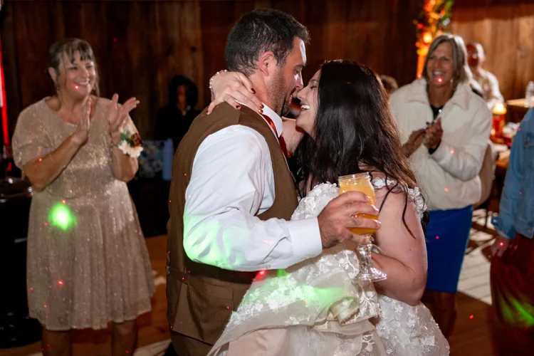 Meagan and Joshua laughing on dance floor at The Watson Homestead Hiram Maine fall wedding photography VMG Productions