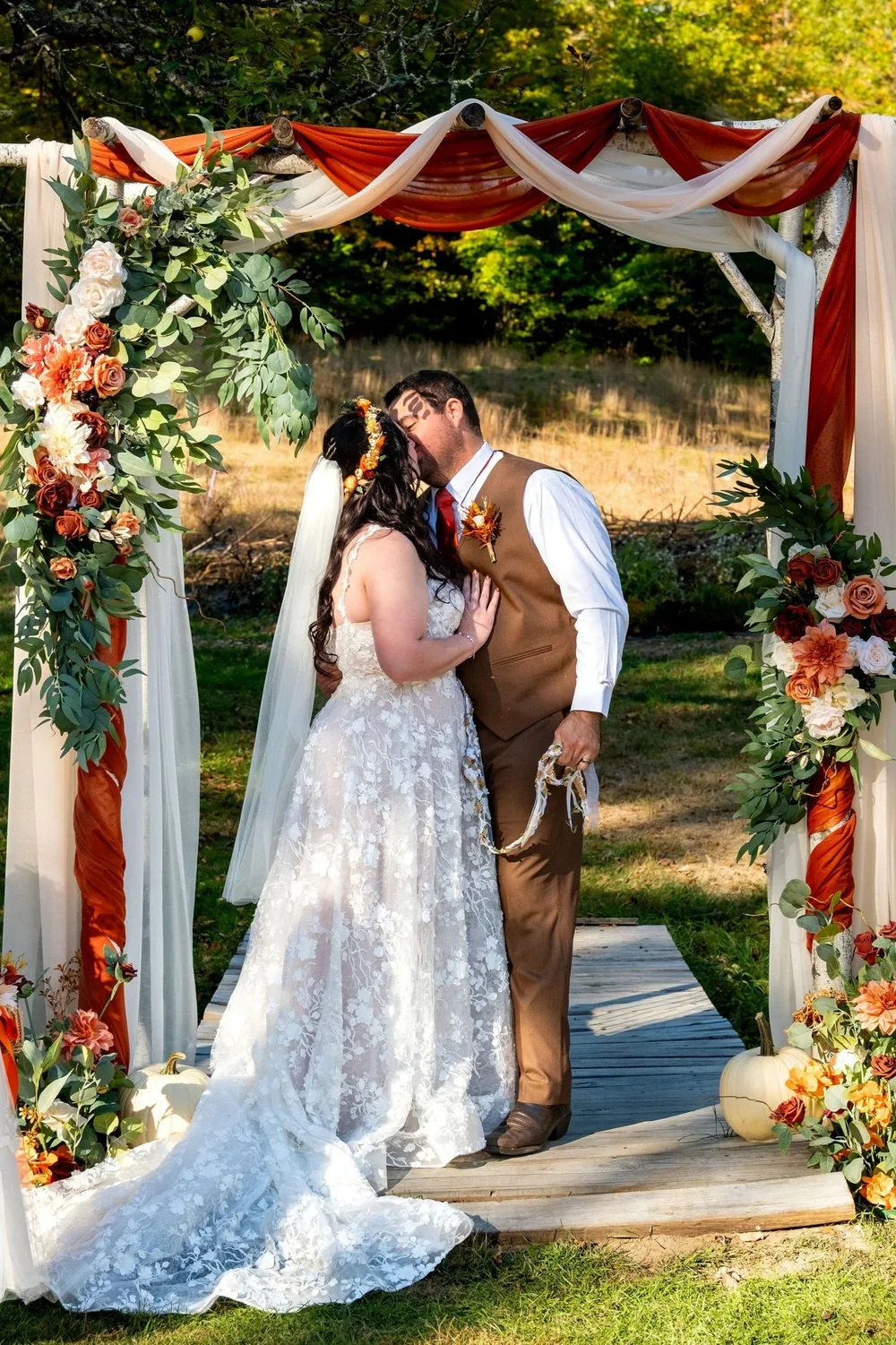 Meagan reading vows to Joshua under floral arch at The Watson Homestead Hiram Maine fall wedding photography VMG Productions