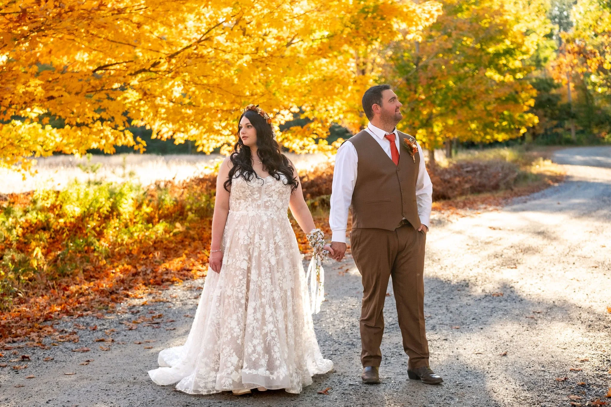 Meagan and Joshua holding hands beneath yellow fall tree at The Watson Homestead Hiram Maine fall wedding photography VMG Productions