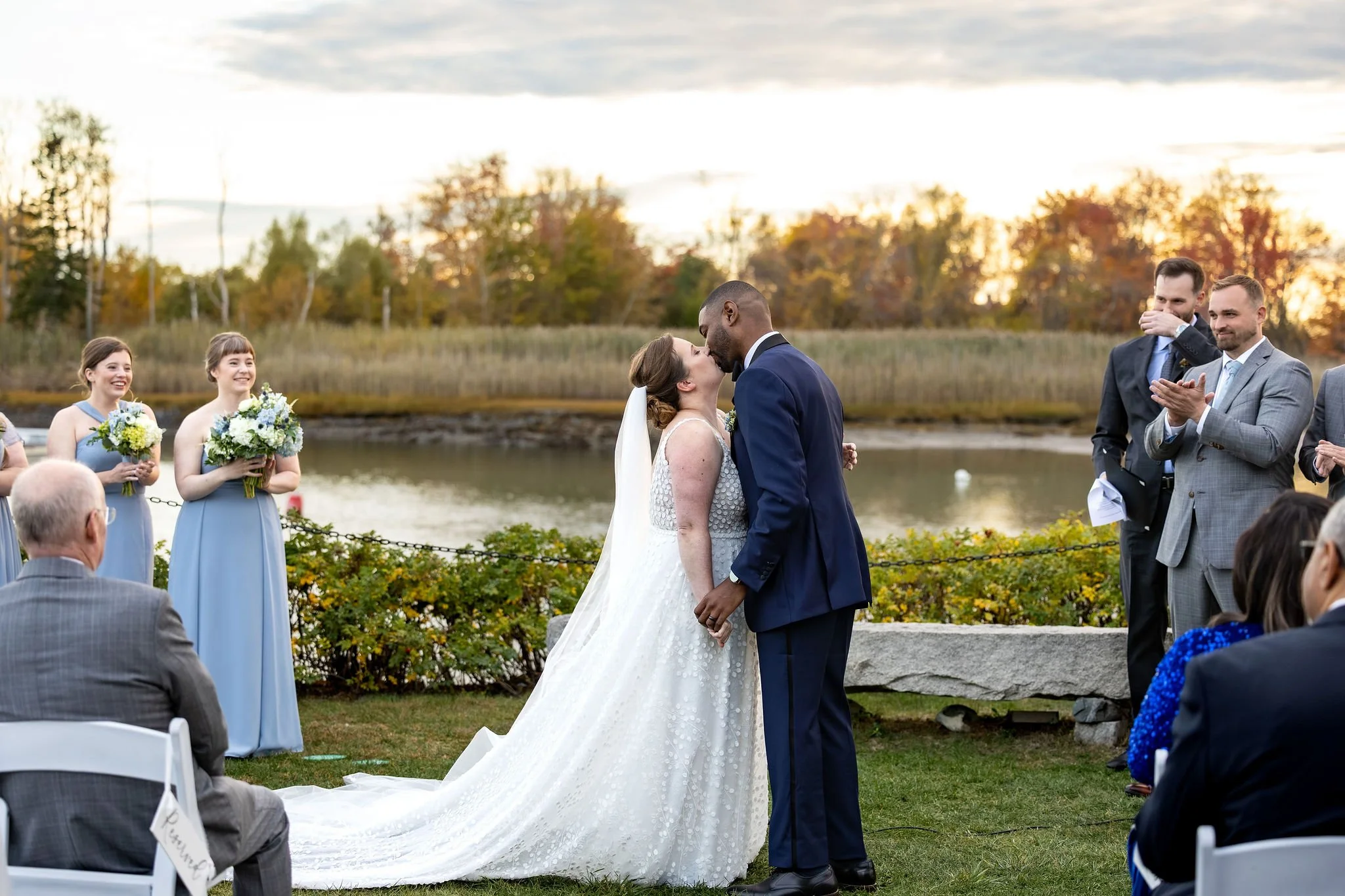 Kaitlyn and Darren first kiss at outdoor ceremony Nonantum Resort Kennebunkport Maine fall wedding photography VMG Productions