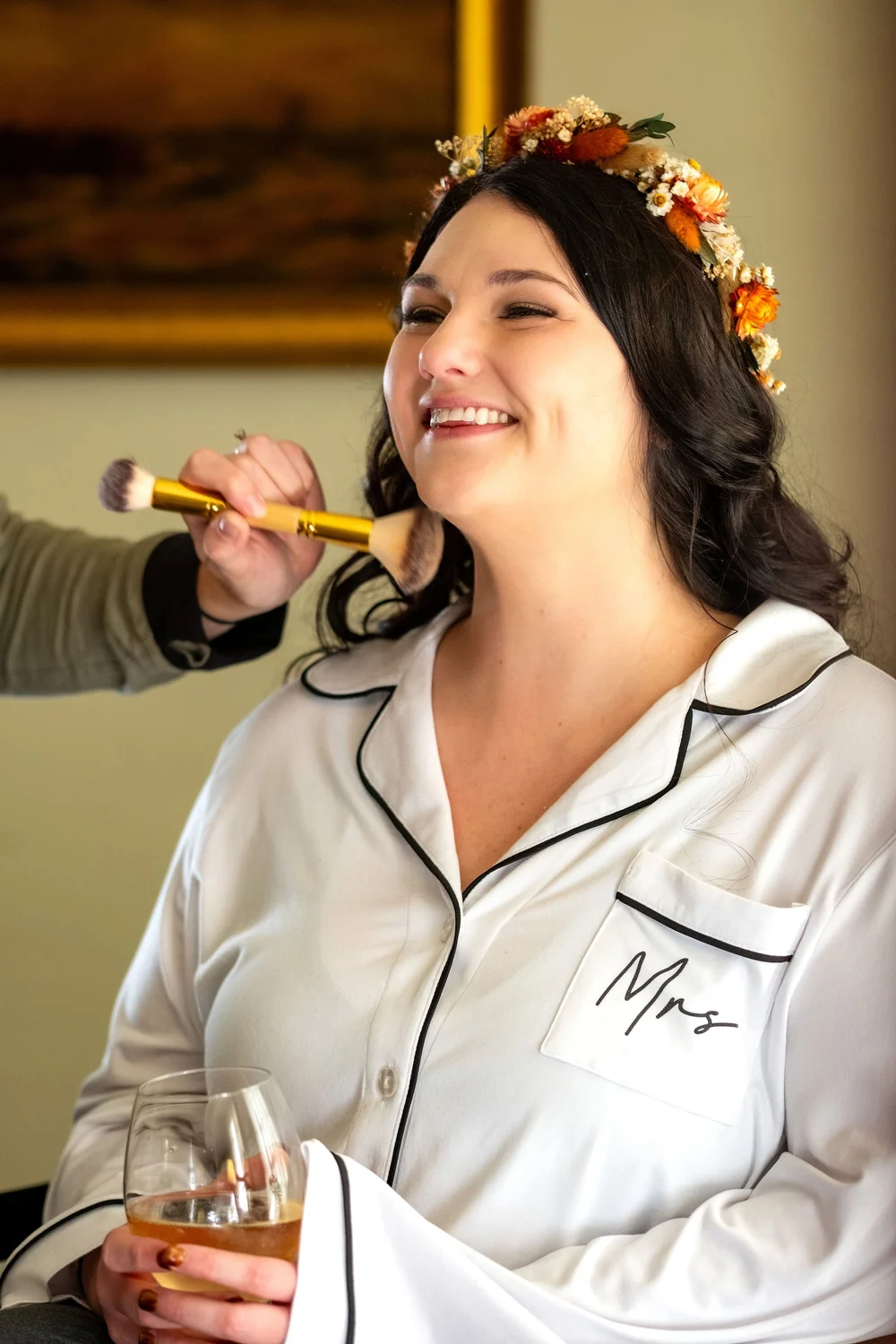 Meagan smiling during makeup in floral crown at The Watson Homestead Hiram Maine fall wedding photography VMG Productions