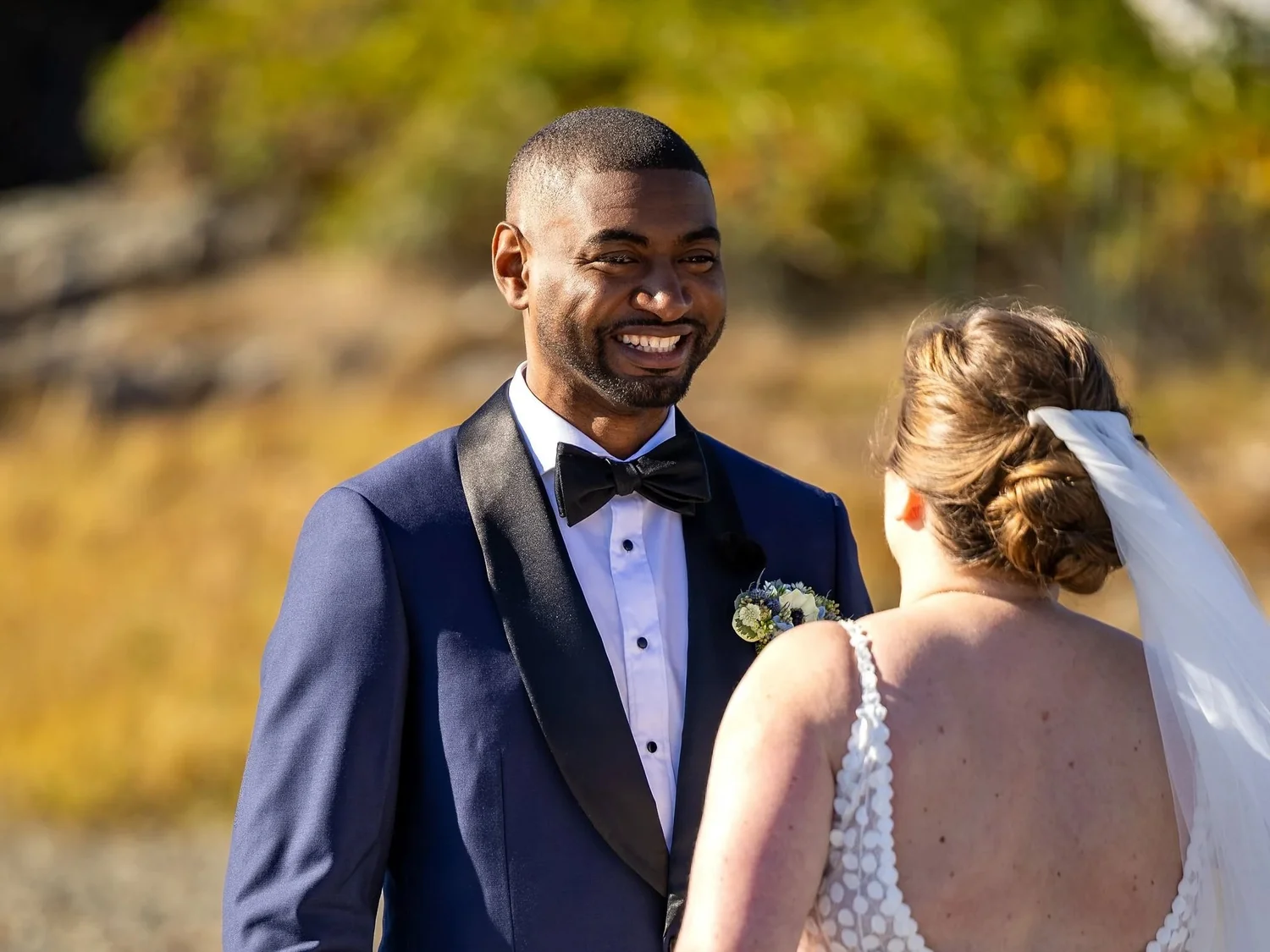 Bride and her father walking along a dock toward a lobster boat in Kennebunkport harbor