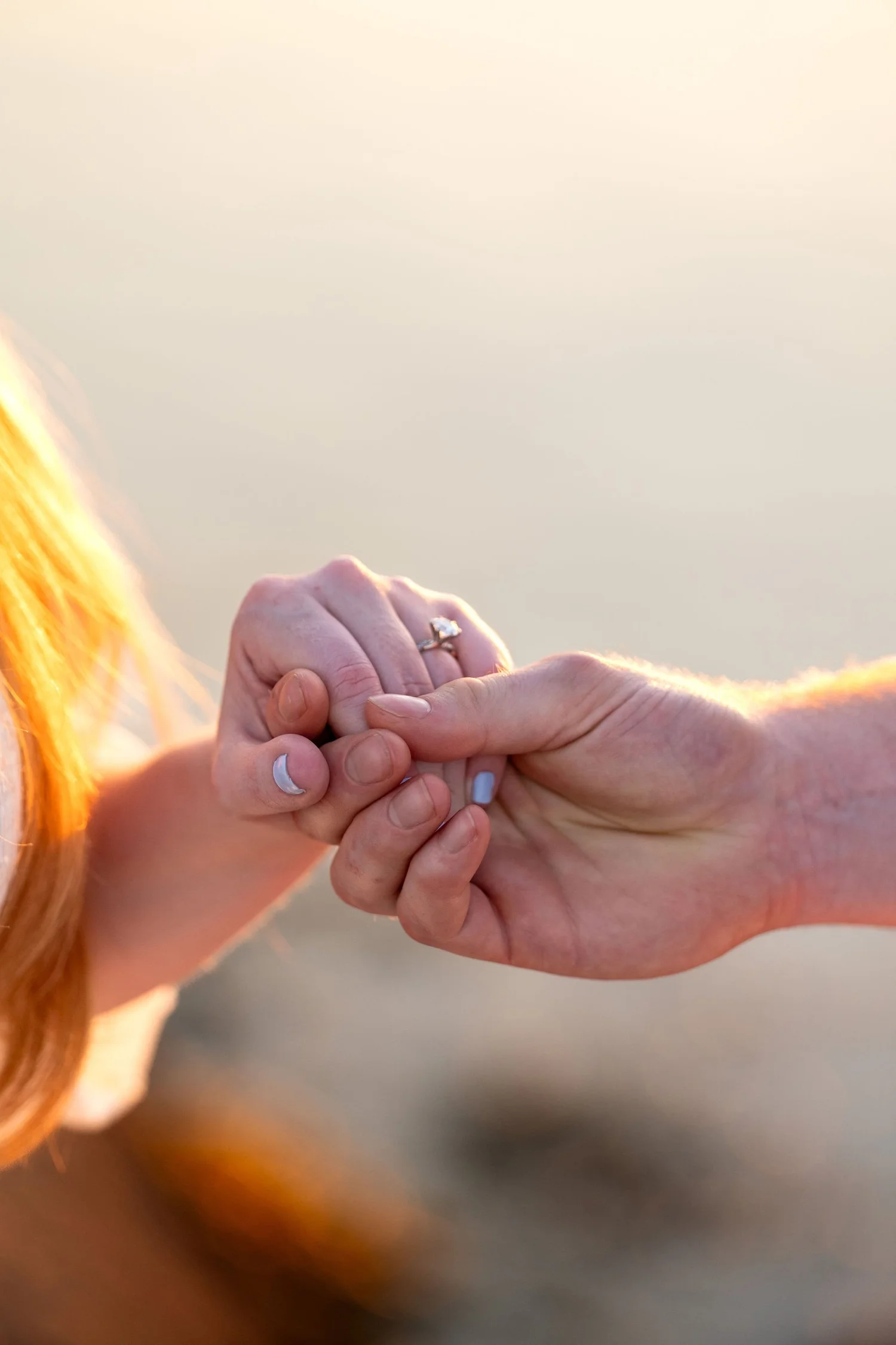 Kayla and Ethan engaged couple hands detail engagement ring golden light sunset Odiorne Point State Park New Hampshire engagement photography VMG Productions