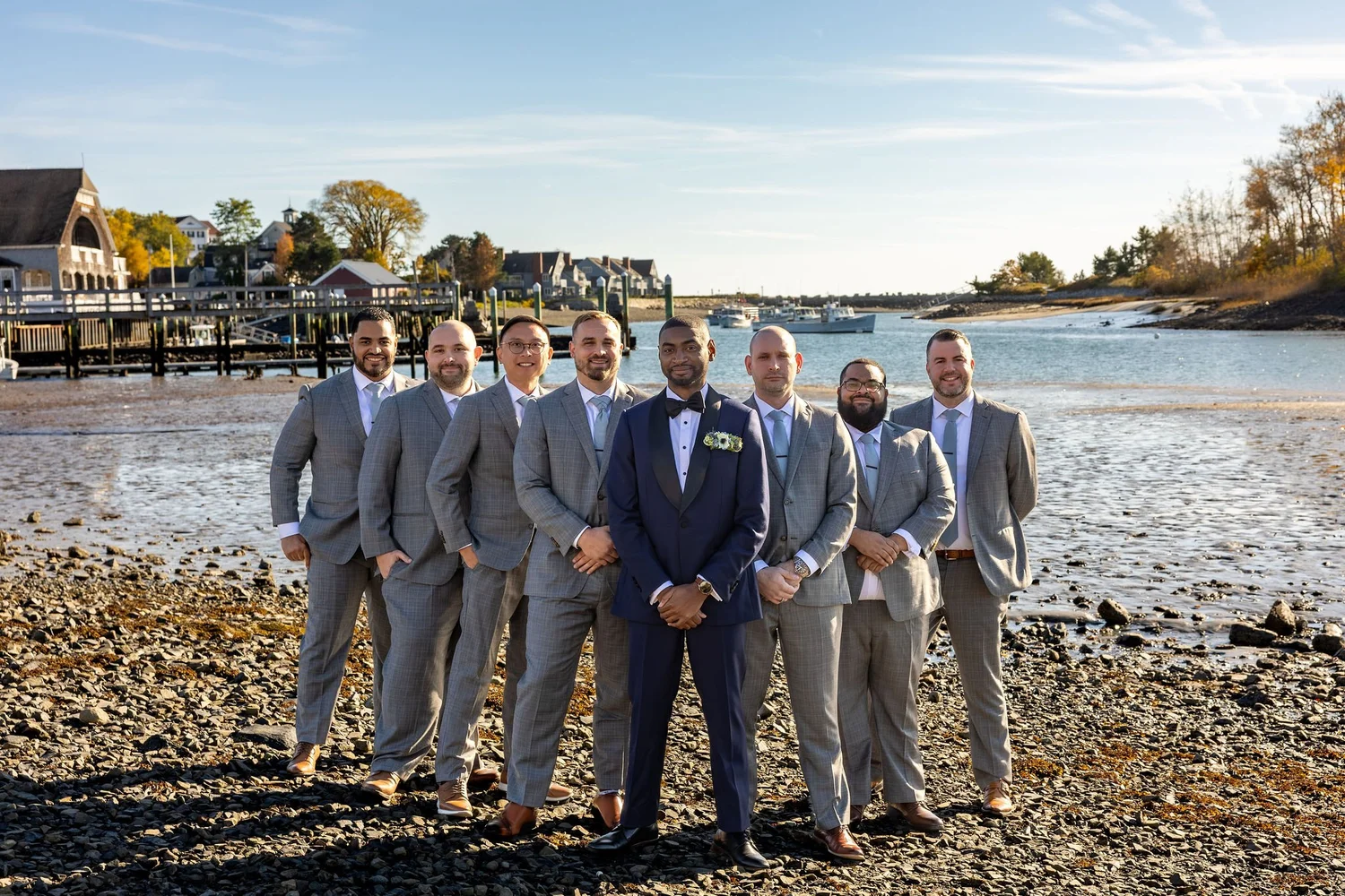 Darren with groomsmen on rocky shoreline Kennebunkport Maine fall wedding photography VMG Productions
