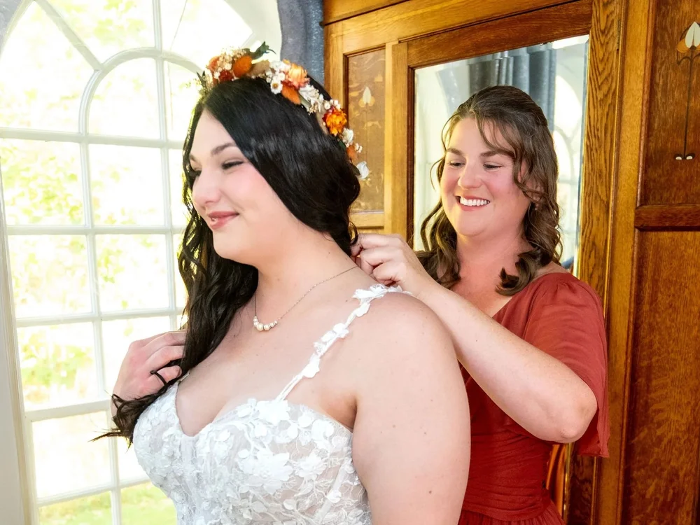 Bridesmaid fastening Meagan dress strap at The Watson Homestead Hiram Maine fall wedding photography VMG Productions