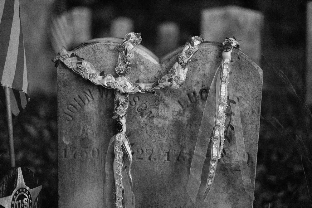 Meagan and Joshua handfasting cord on gravestone detail at The Watson Homestead Hiram Maine fall wedding photography VMG Productions