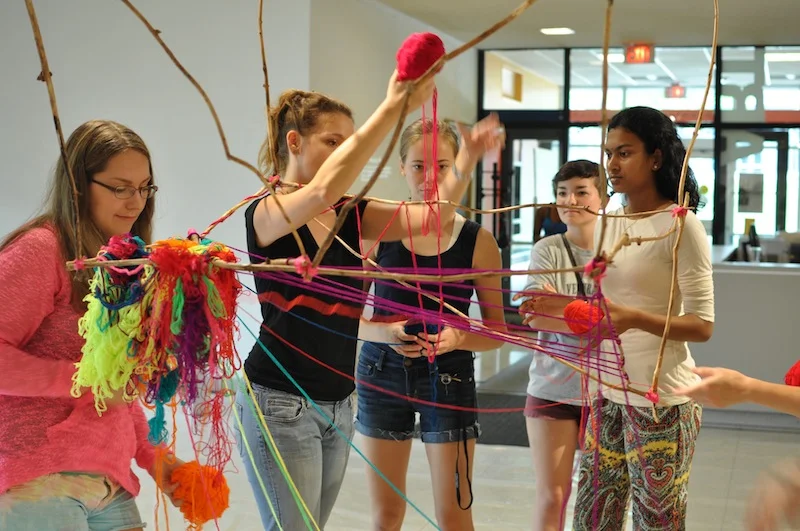 Heather  Brand and students assist Alicia Marván