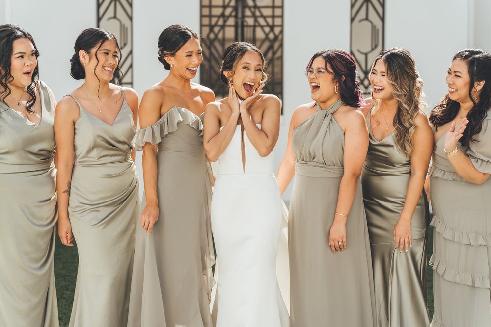 Southern Palms Studio bride poses with her bridesmaids outside historic The Clay Theatre in St. Augustine, FL ahead of her wedding ceremony.jpg