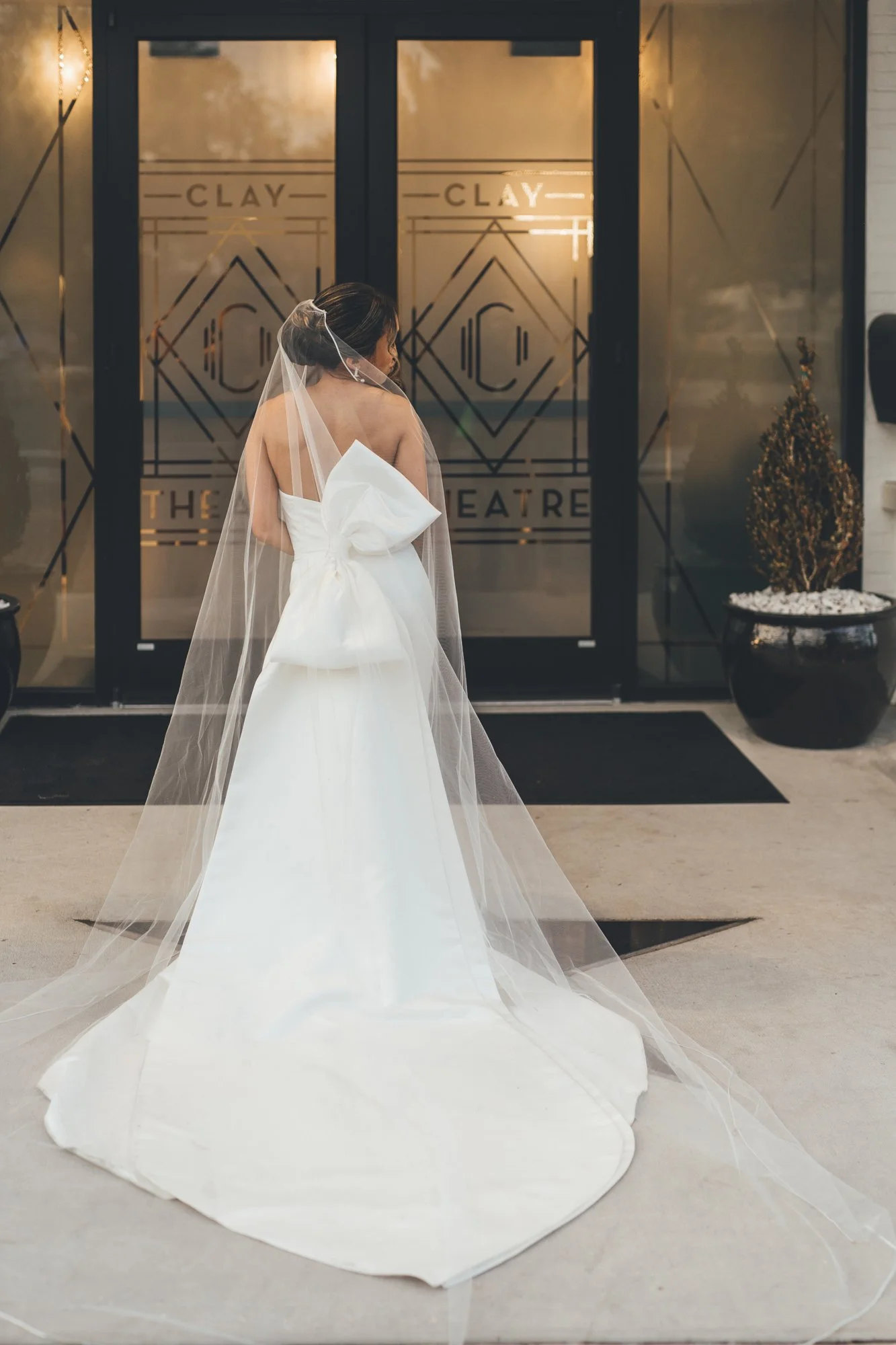 Southern Palms Studio bride poses outside historic The Clay Theatre in St. Augustine, FL ahead of her wedding ceremony.jpg