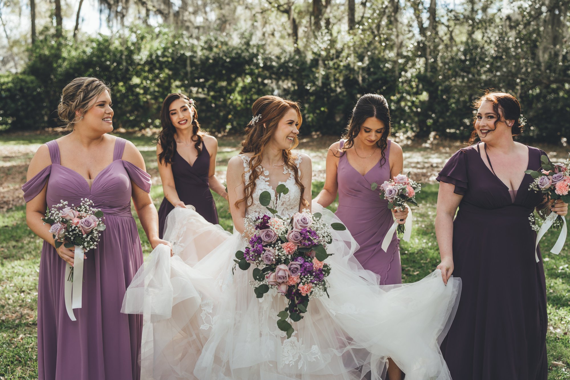 Southern Palms Studio bride walking with her bridesmaids at Bowing Oaks in Jacksonville, FL.jpg