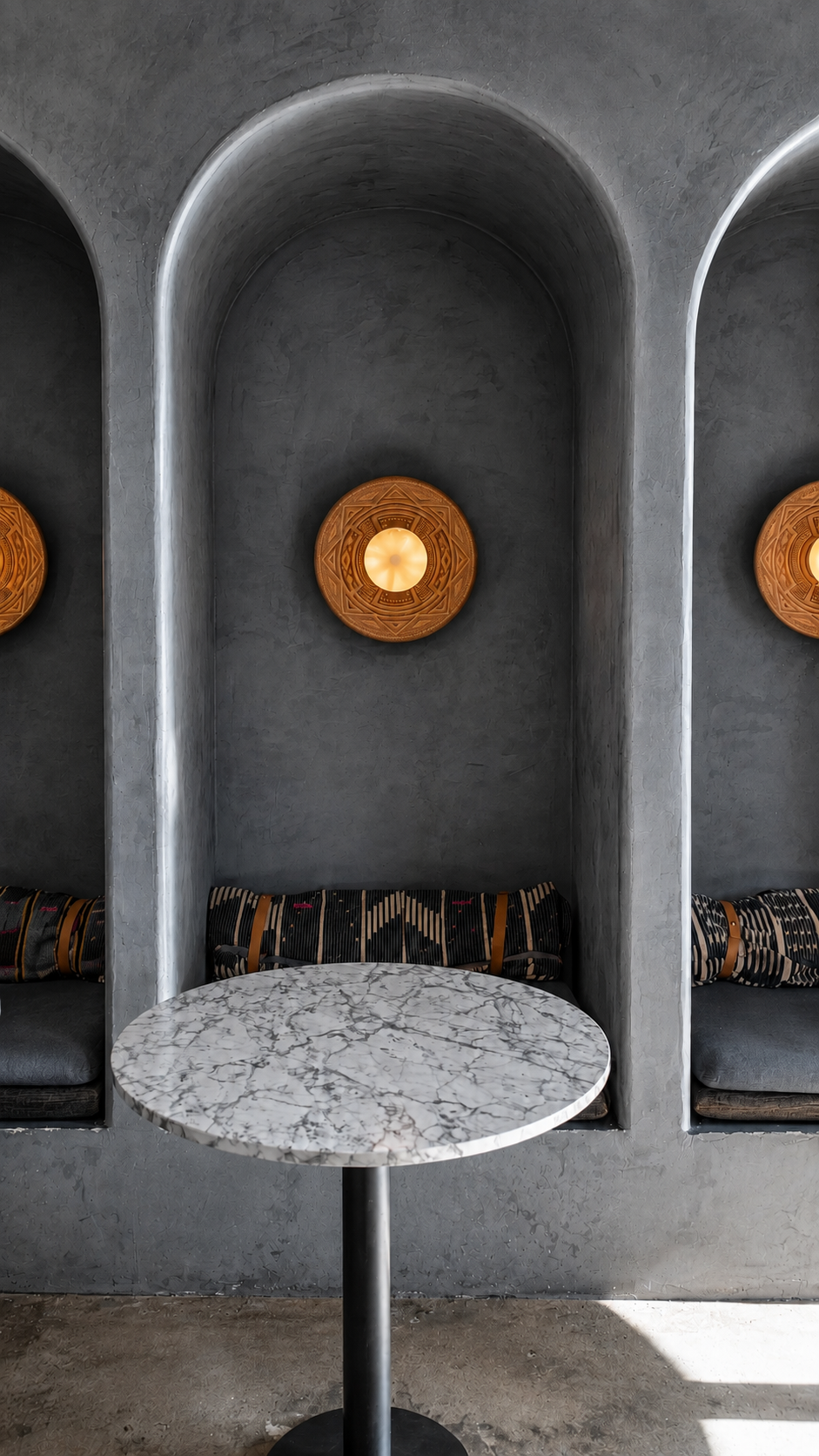 Charcoal arches and honey-gold fixtures.png