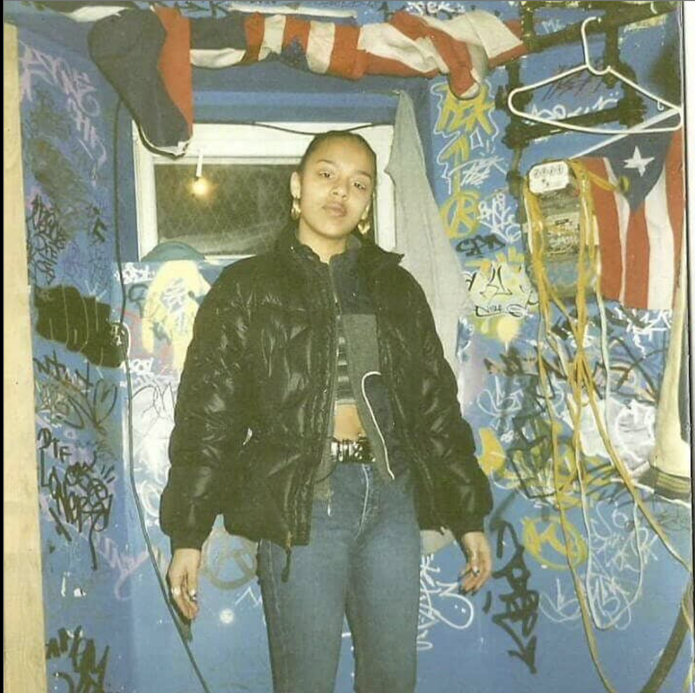 “This was 1999. I was 15 years old running with the graff heads. This was at the chill spot by Franklin K Lane High School. I had the white eyeliner, north face diamond bubble, sesame chicken timbs. What a time to be alive.” – Shio